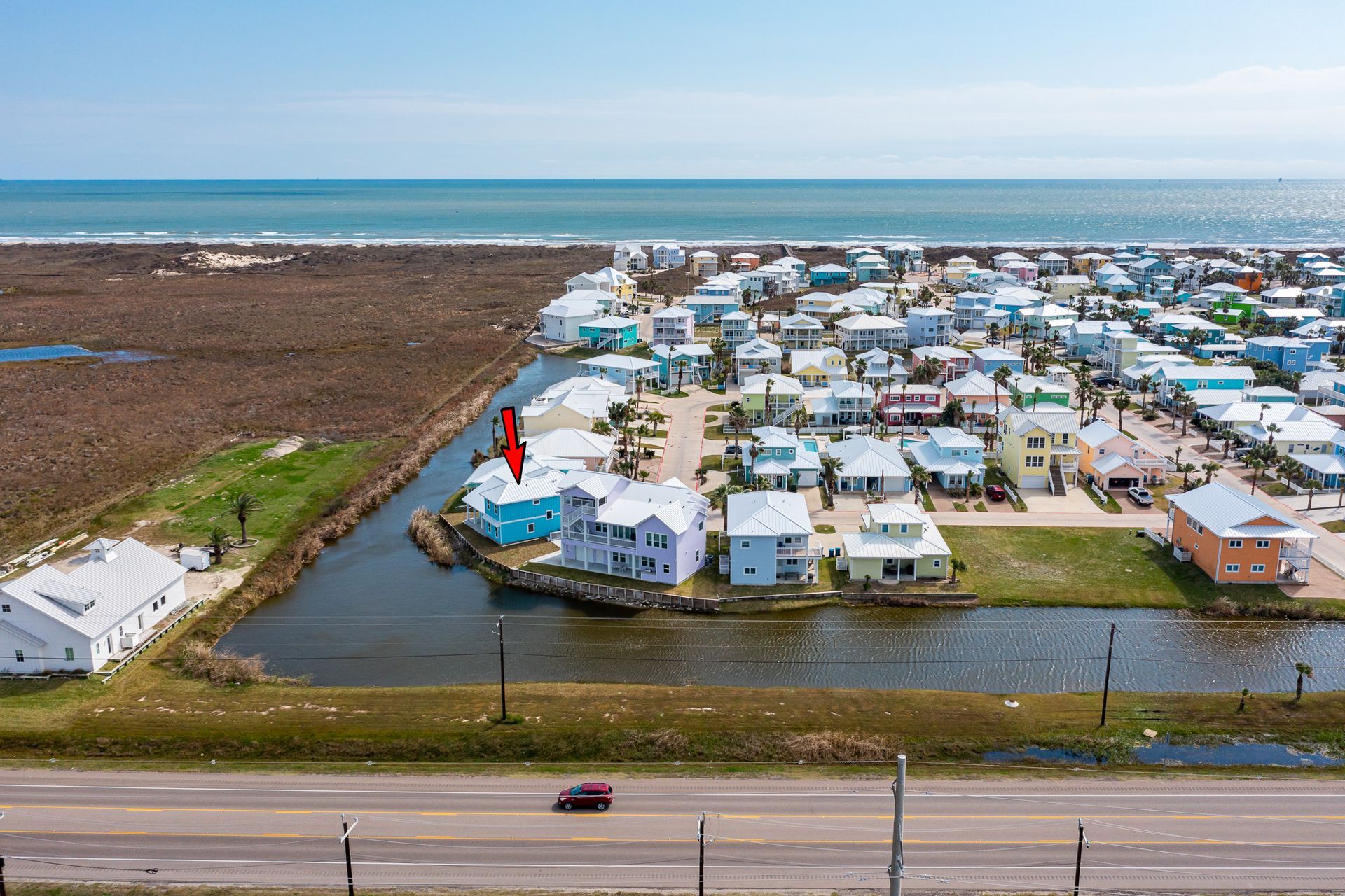 An aerial view of a small town next to the ocean.