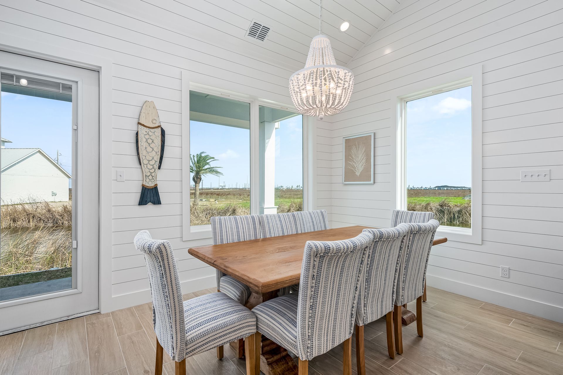 A dining room with a table and chairs and a chandelier.