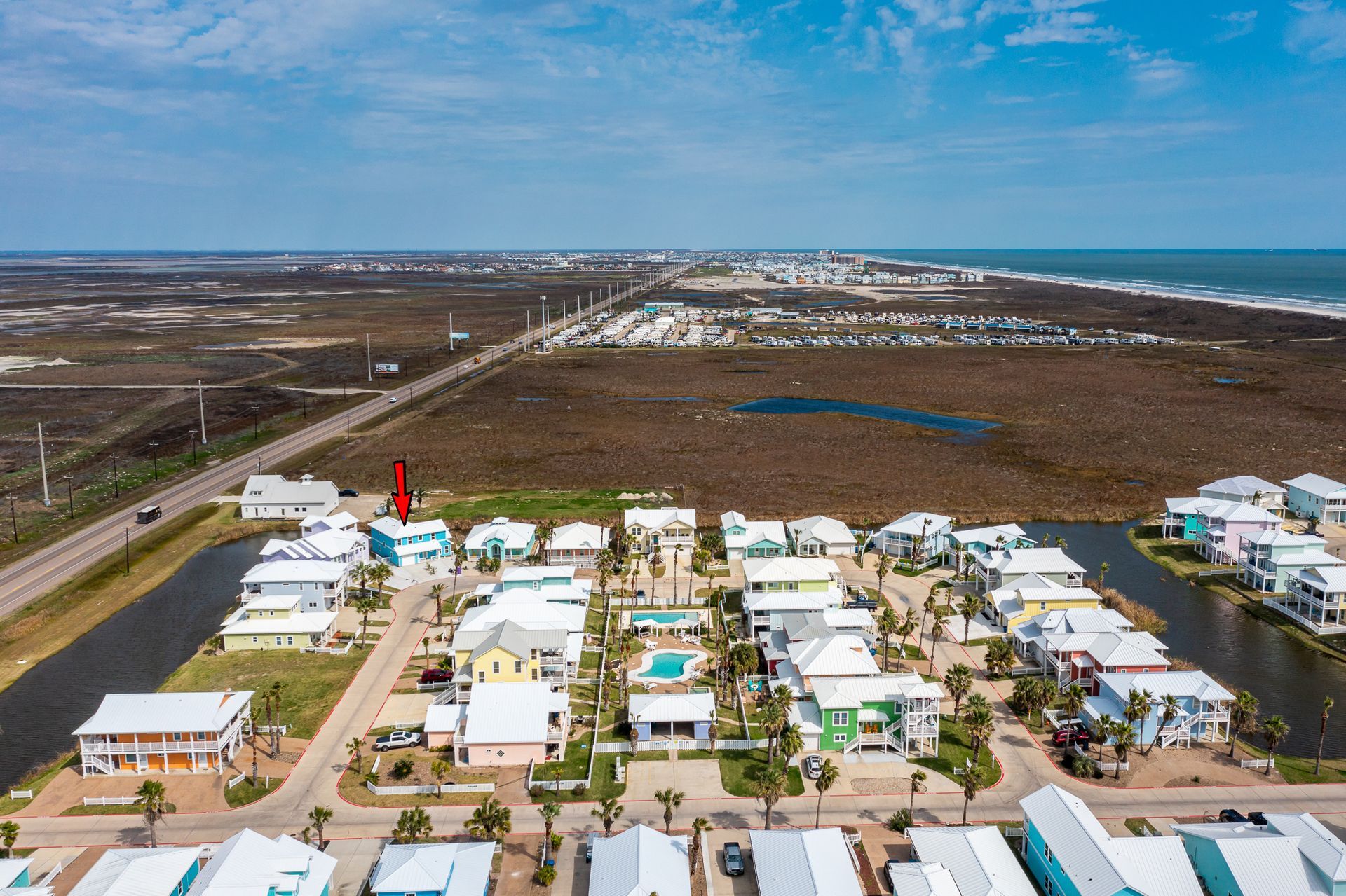 An aerial view of a residential area next to the ocean.