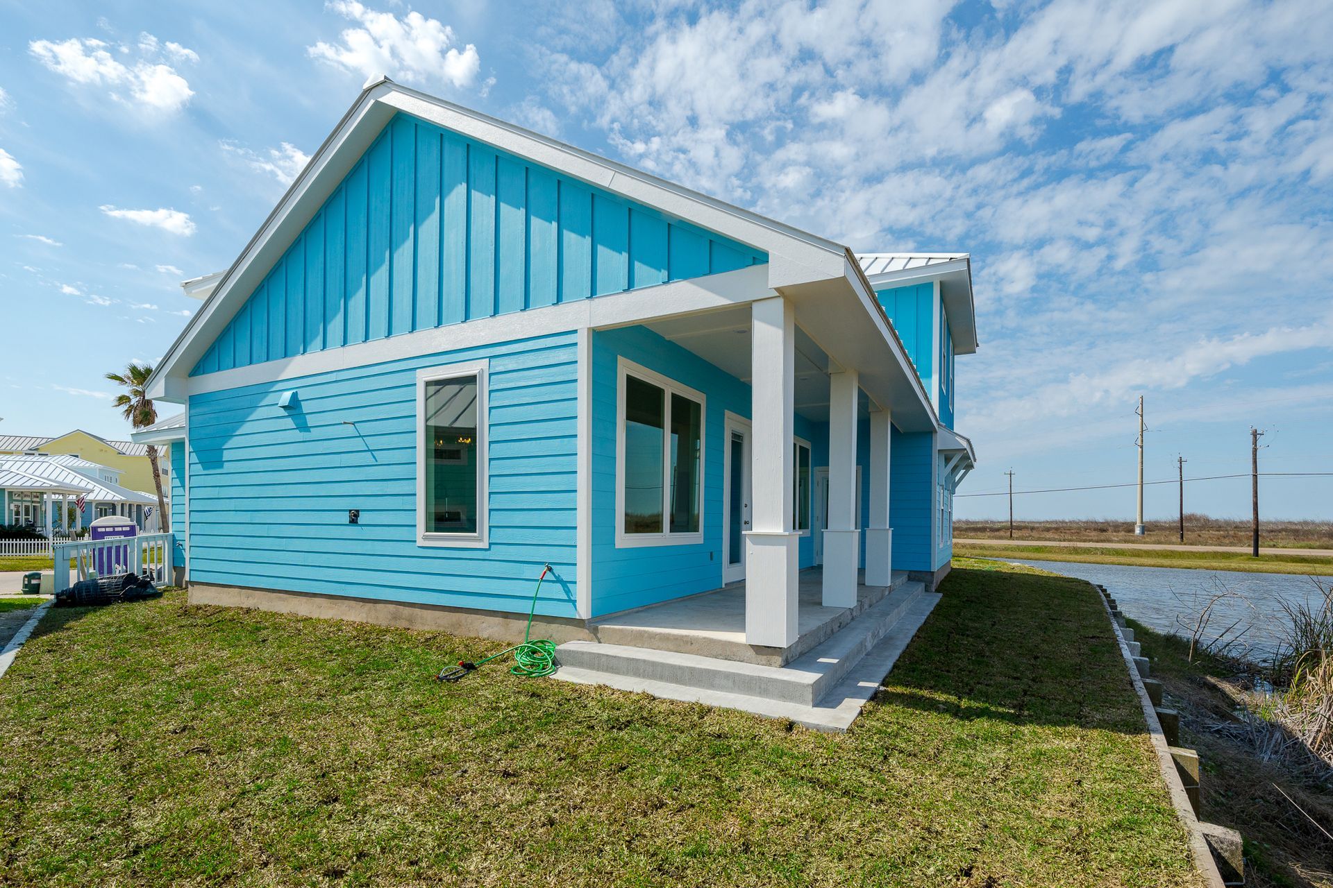 A blue house with white trim and a porch