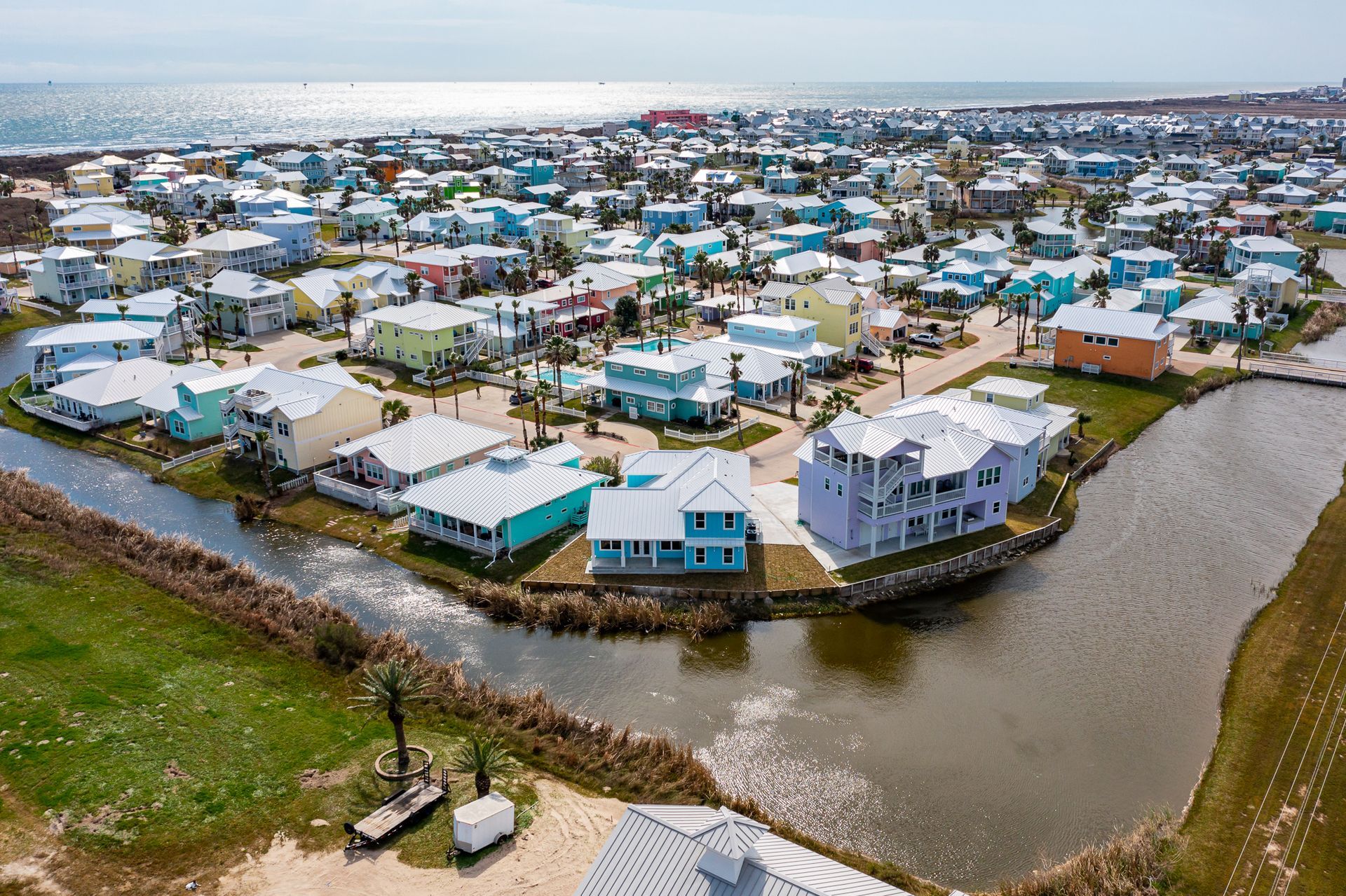 An aerial view of a residential area next to the ocean.