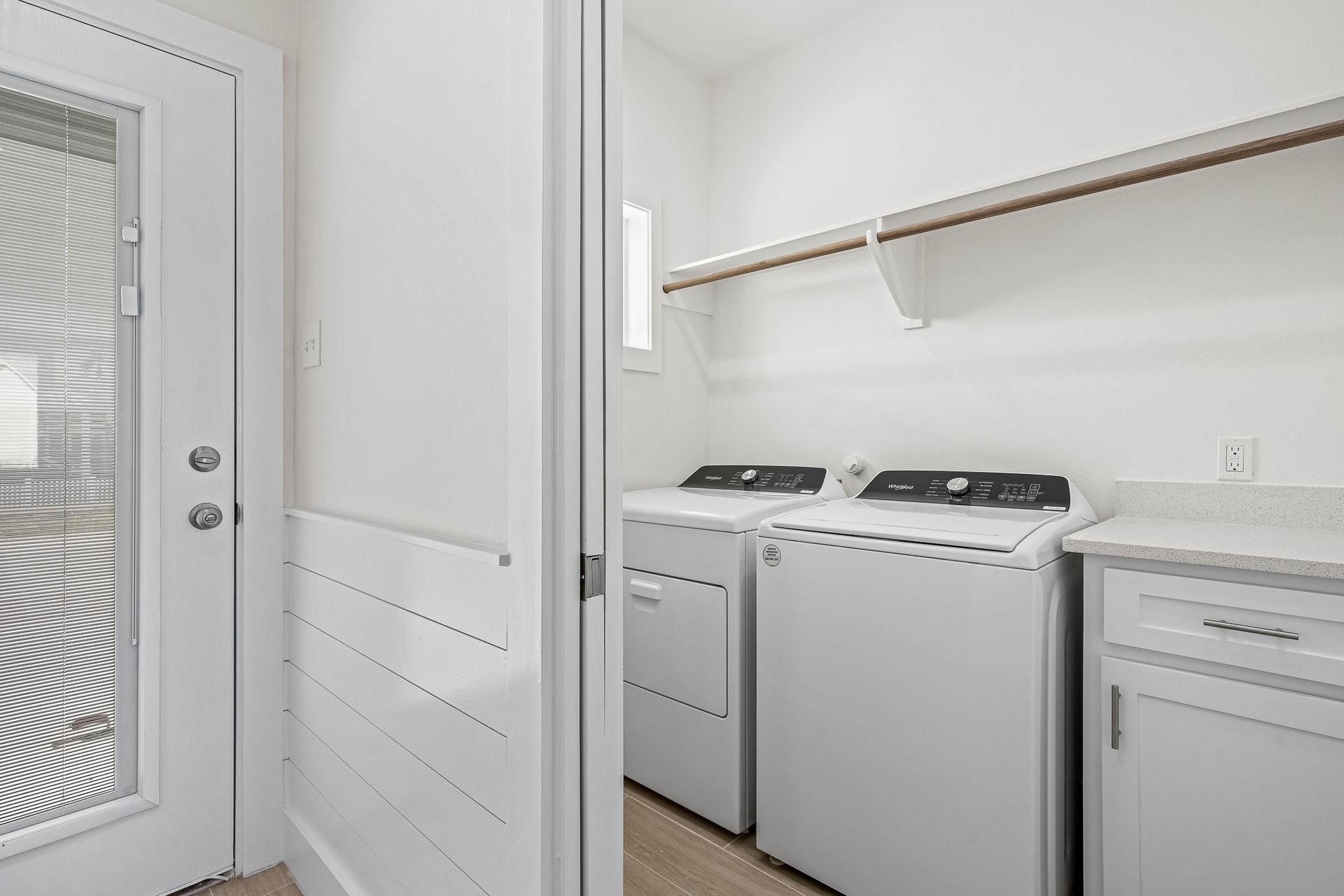 A laundry room with a washer and dryer and a dishwasher.