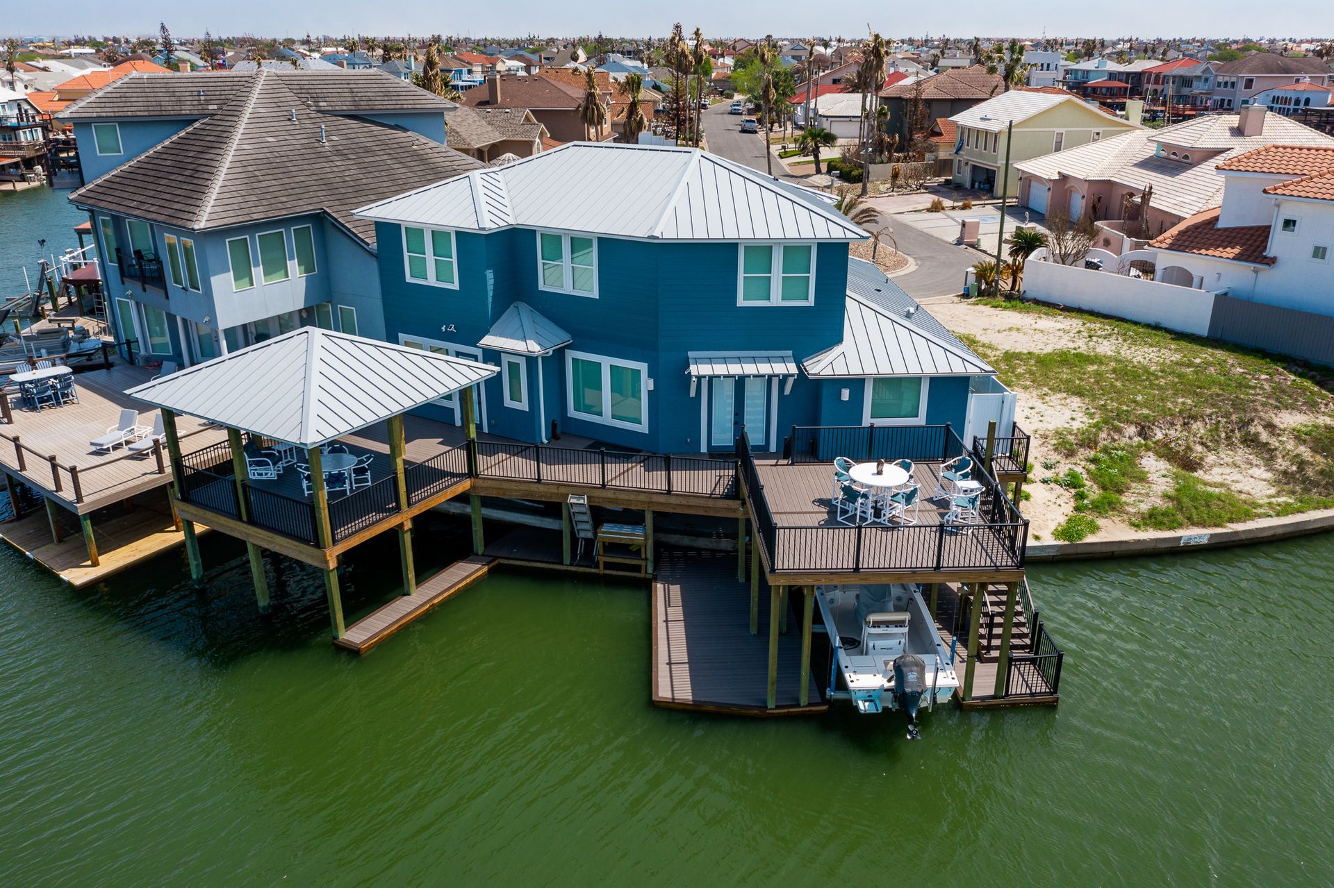An aerial view of a house sitting on top of a body of water