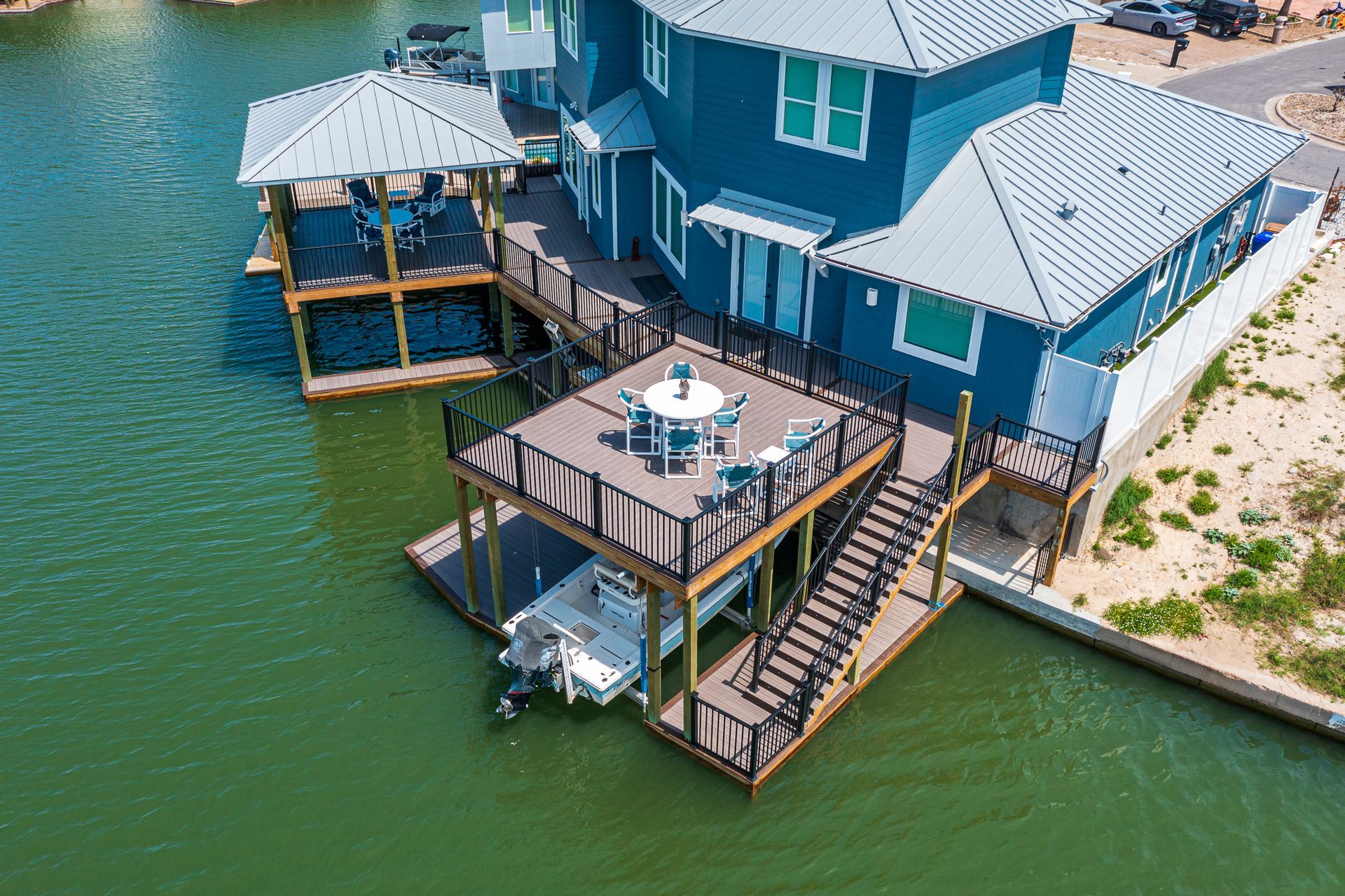 An aerial view of a house with a boat docked in front of it.