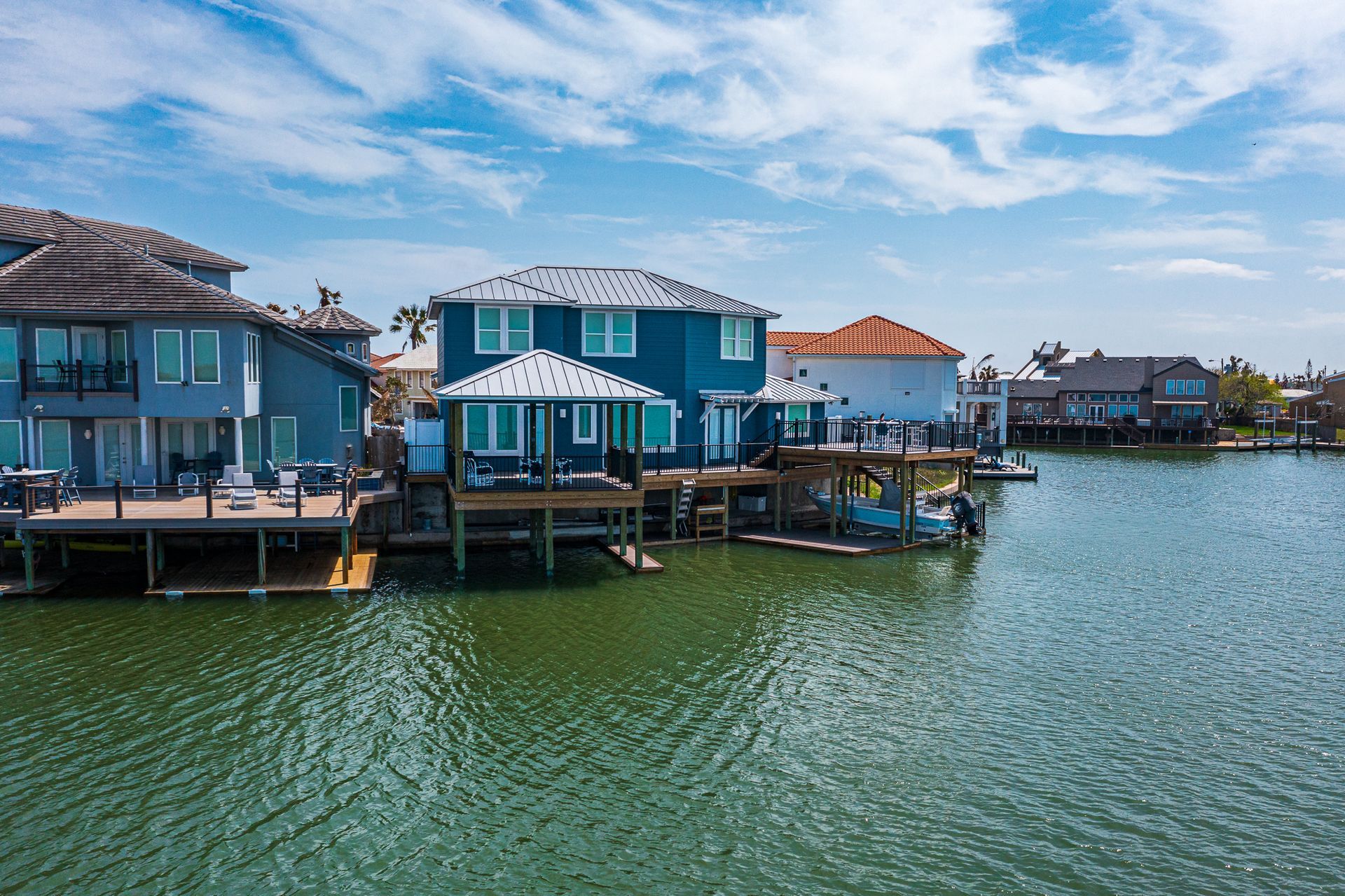 A group of houses sitting on top of a body of water.