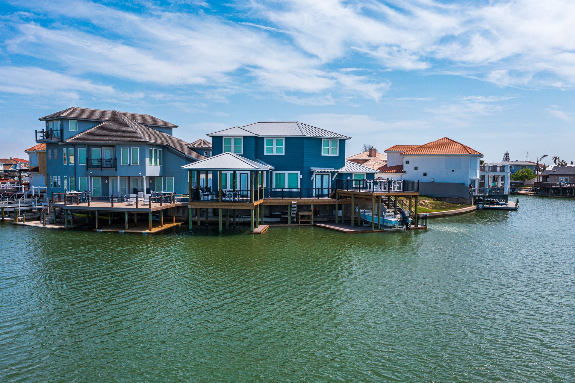 A group of houses sitting on top of a body of water.