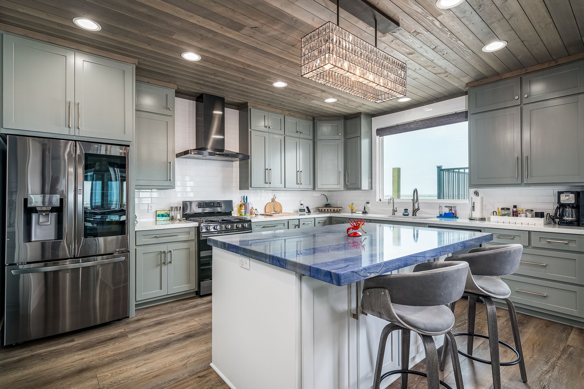 A kitchen with stainless steel appliances and a large island.