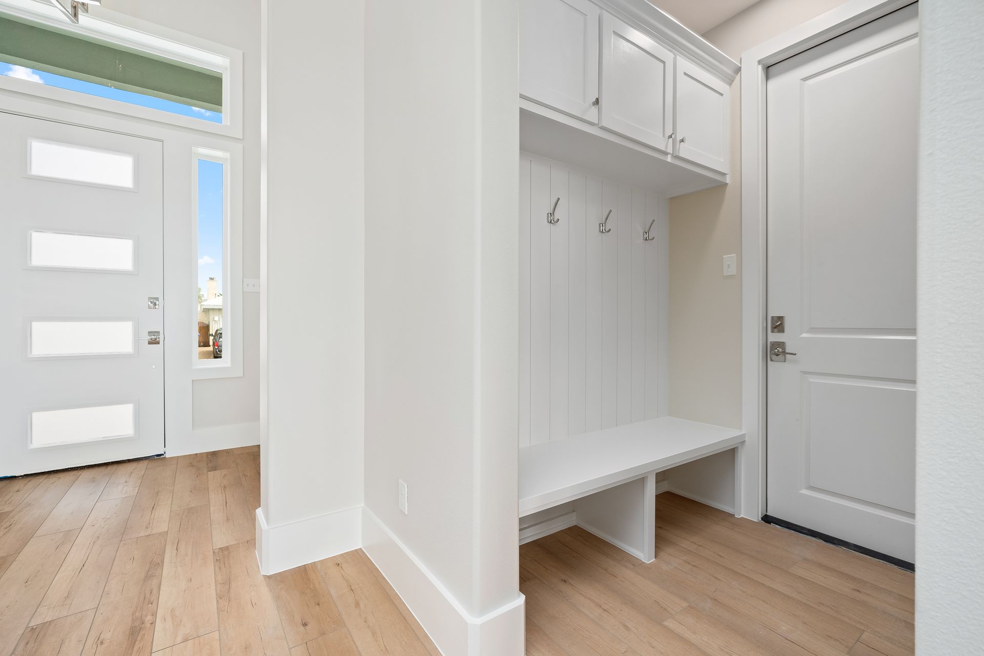 There is a bench in the middle of the hallway.