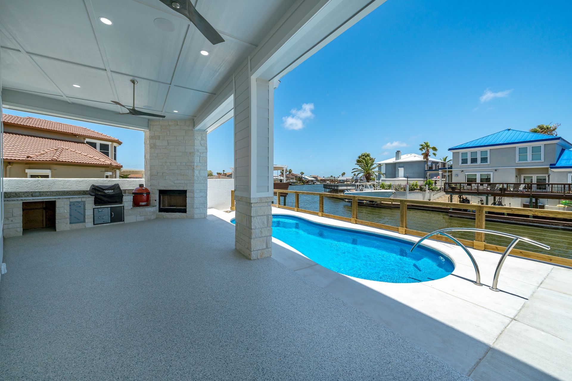 A large swimming pool is in the backyard of a house