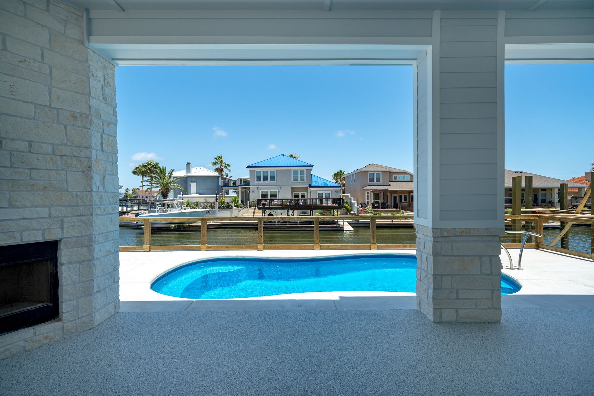A view of a swimming pool from the inside of a house