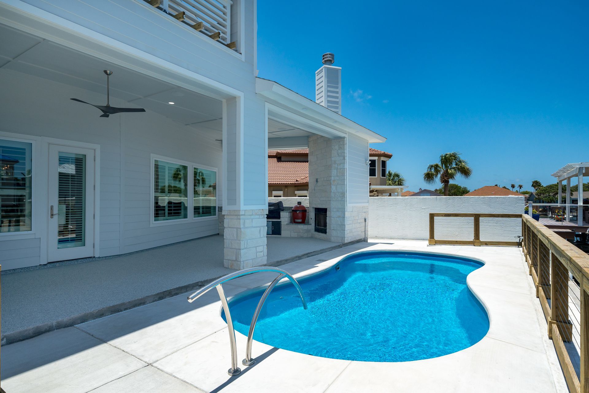 A large white house with a swimming pool in front of it