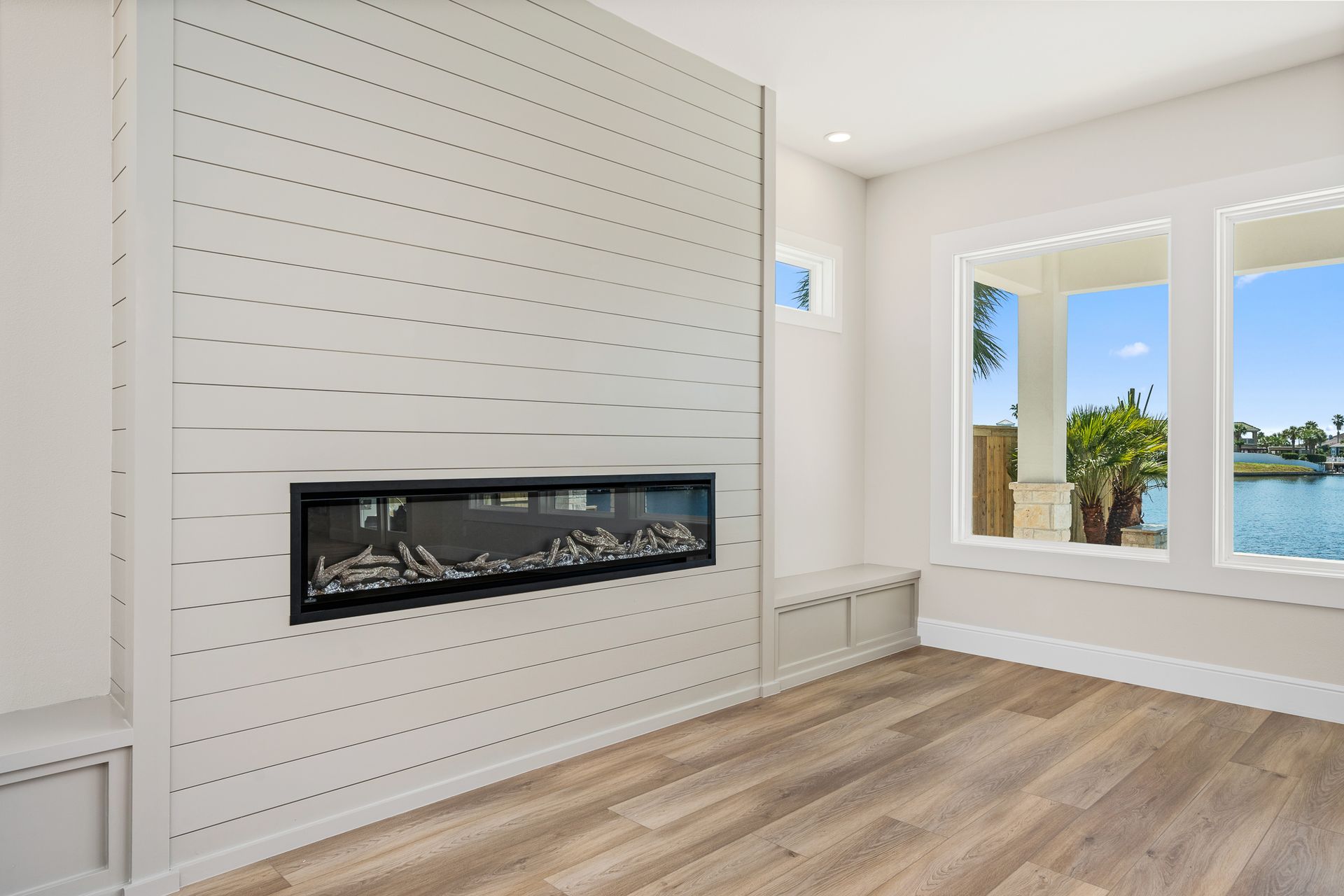 A living room with a fireplace and a large window