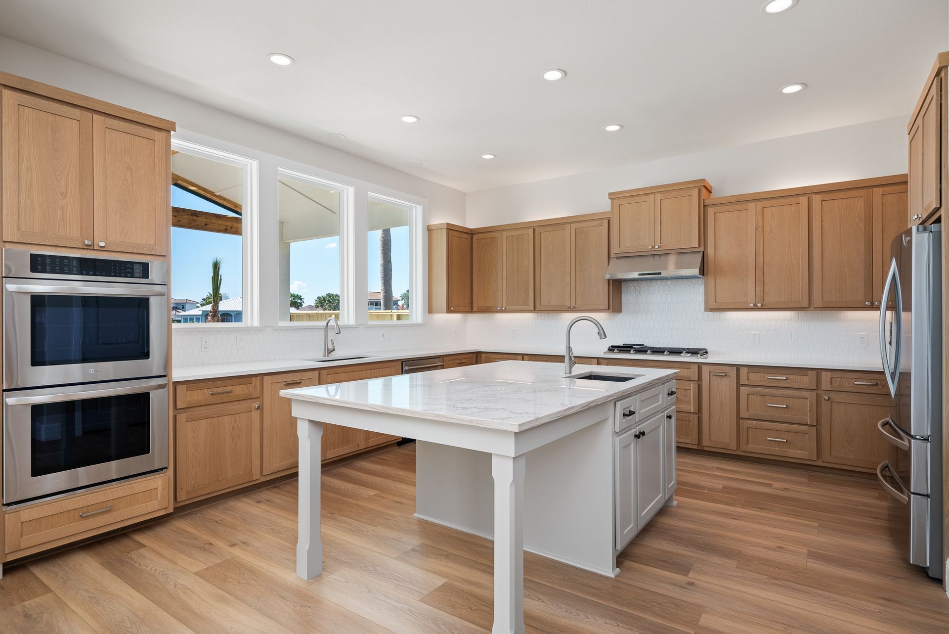 A kitchen with wooden cabinets and stainless steel appliances