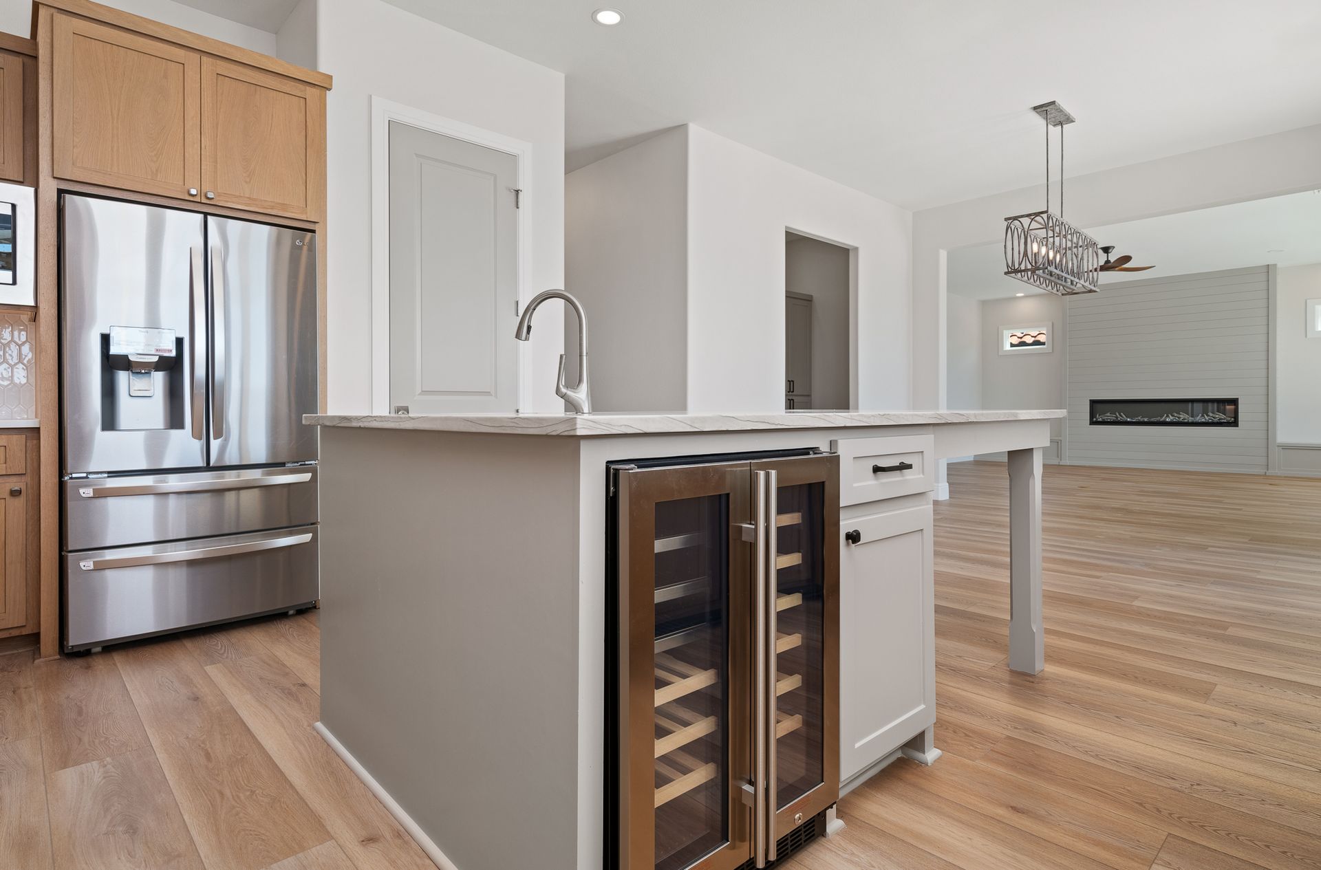 A kitchen with stainless steel appliances and a wine cooler
