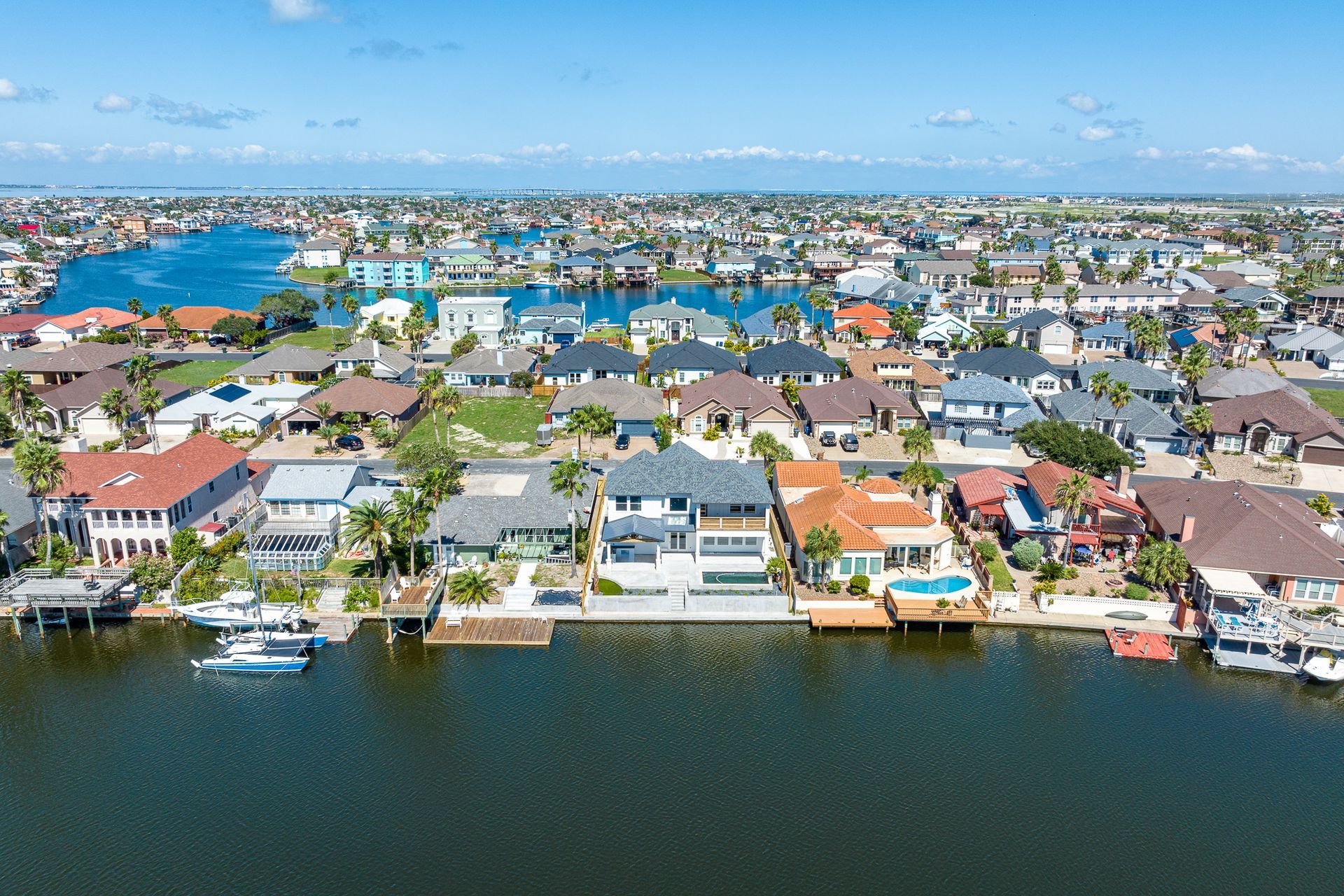 An aerial view of a residential area next to a body of water.