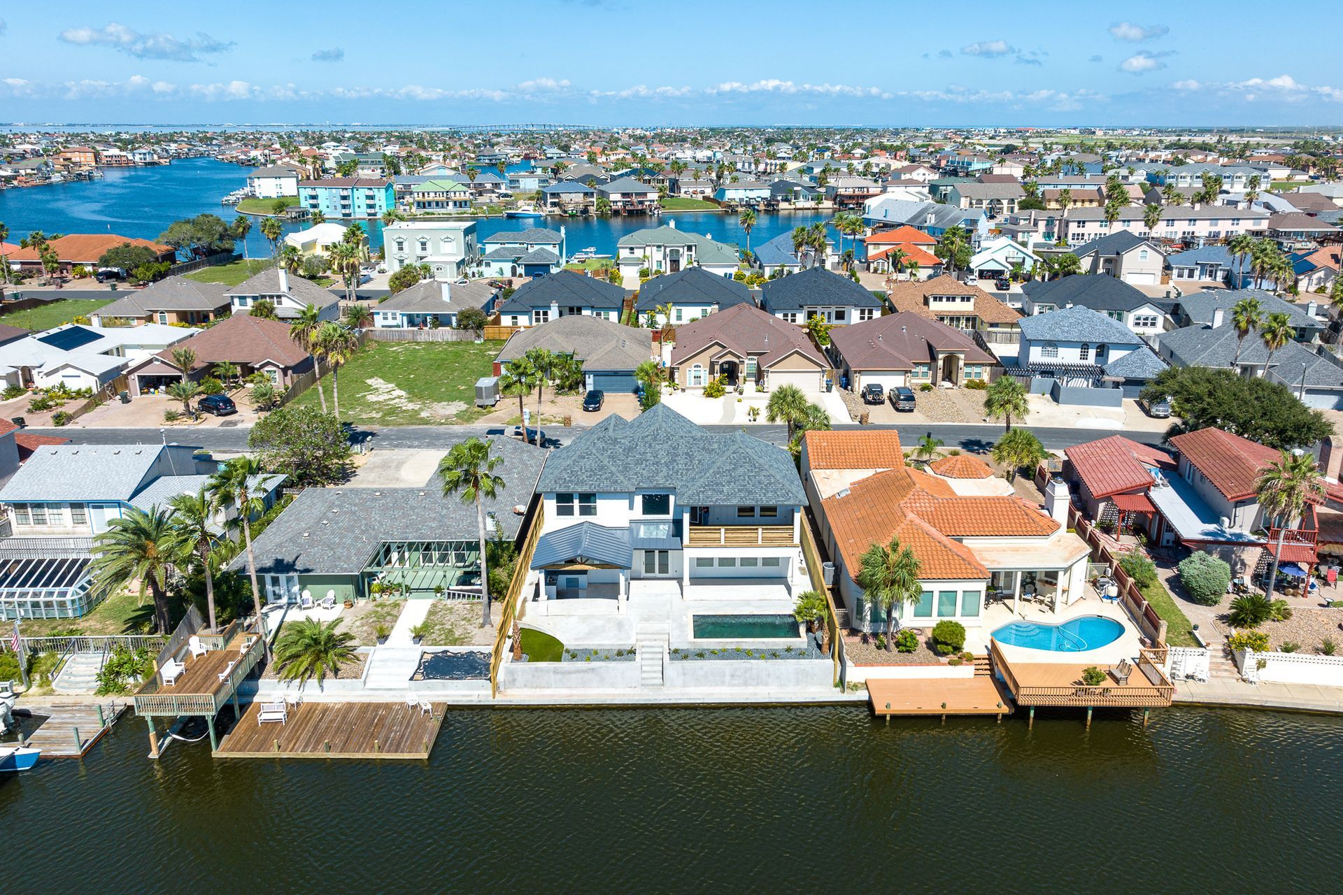 An aerial view of a residential area next to a body of water.