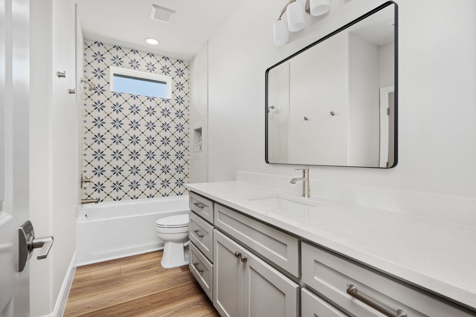 A bathroom with a sink , toilet , and mirror.