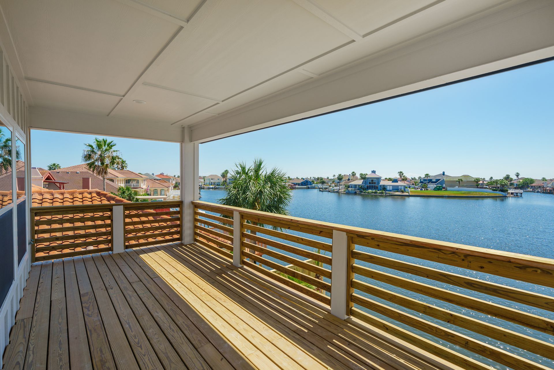 An empty deck with a view of a body of water