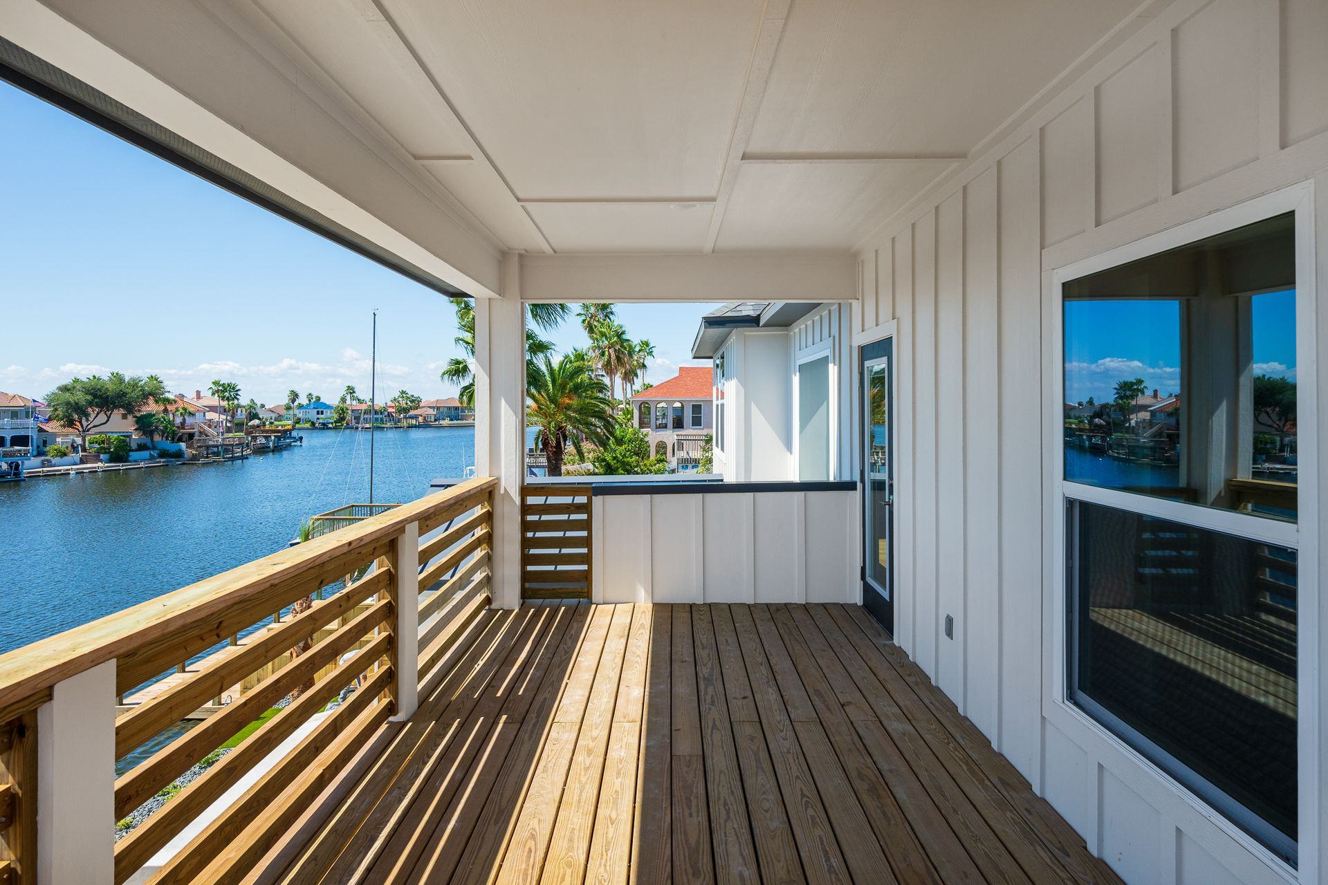 A large porch with a view of a body of water