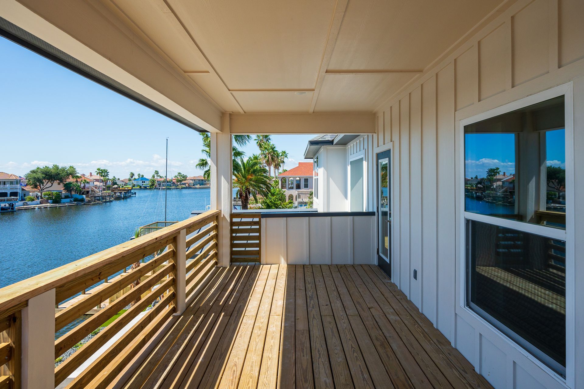 A large porch with a view of a body of water