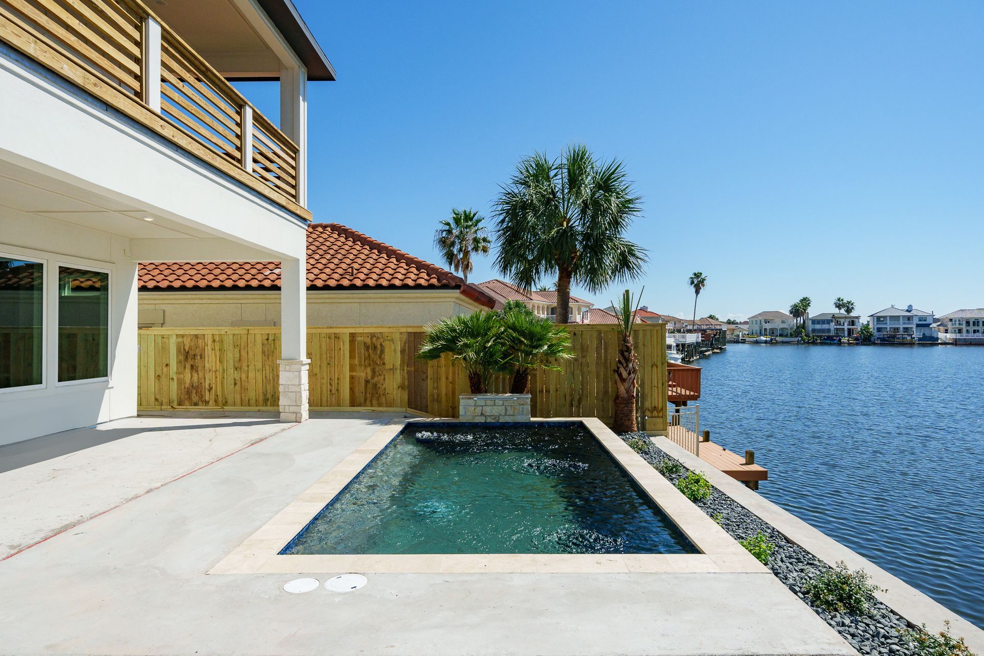 A large house with a swimming pool in front of it