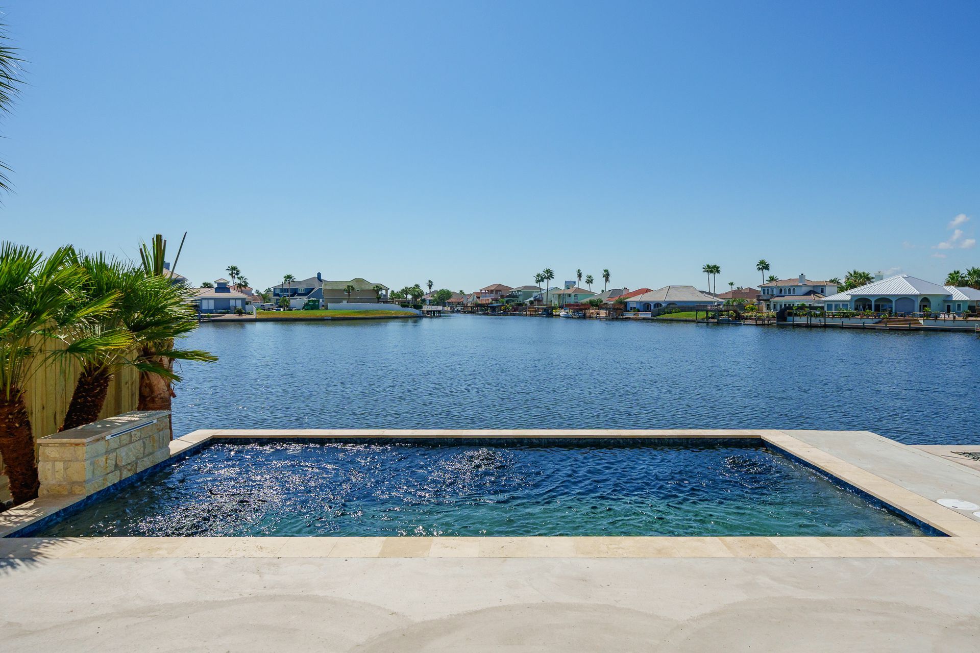 A swimming pool with a view of a large body of water