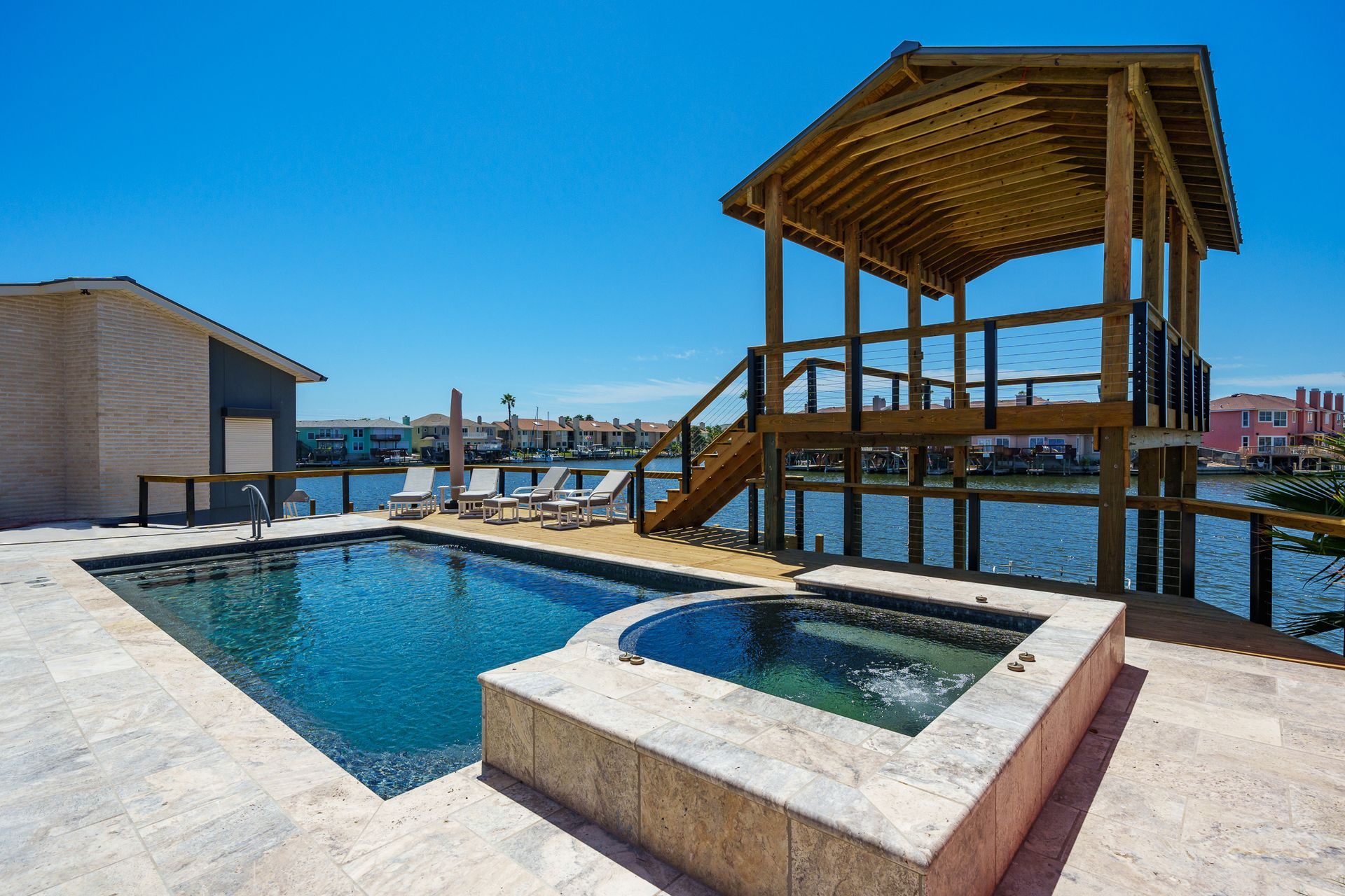 A large swimming pool with a gazebo in the background