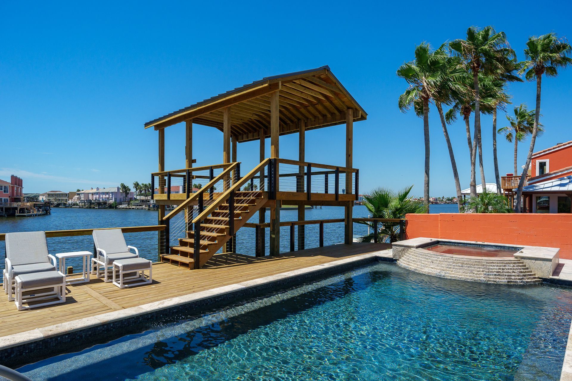 A large swimming pool with a gazebo in the background