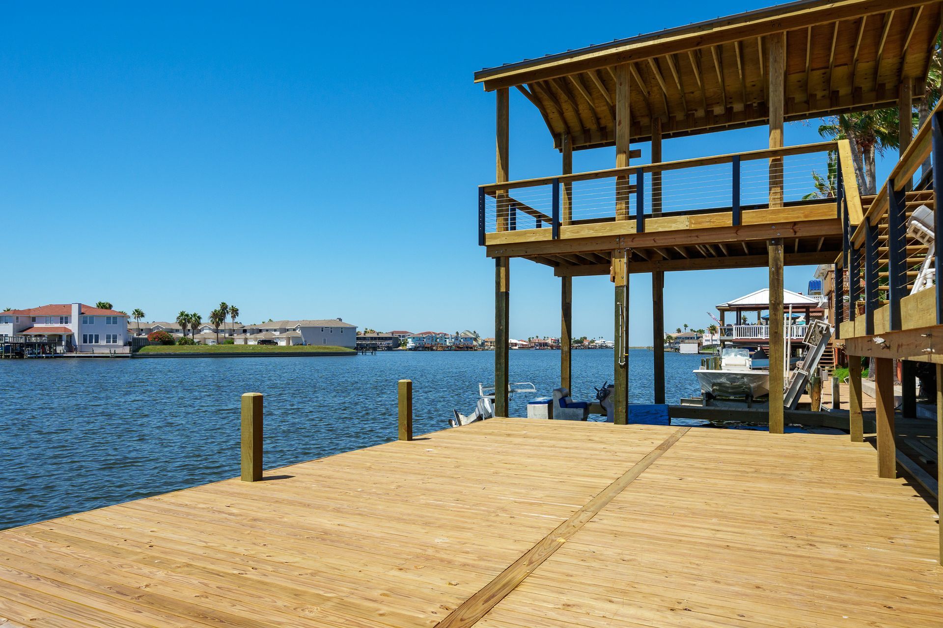 A boat is docked at a dock with a house in the background