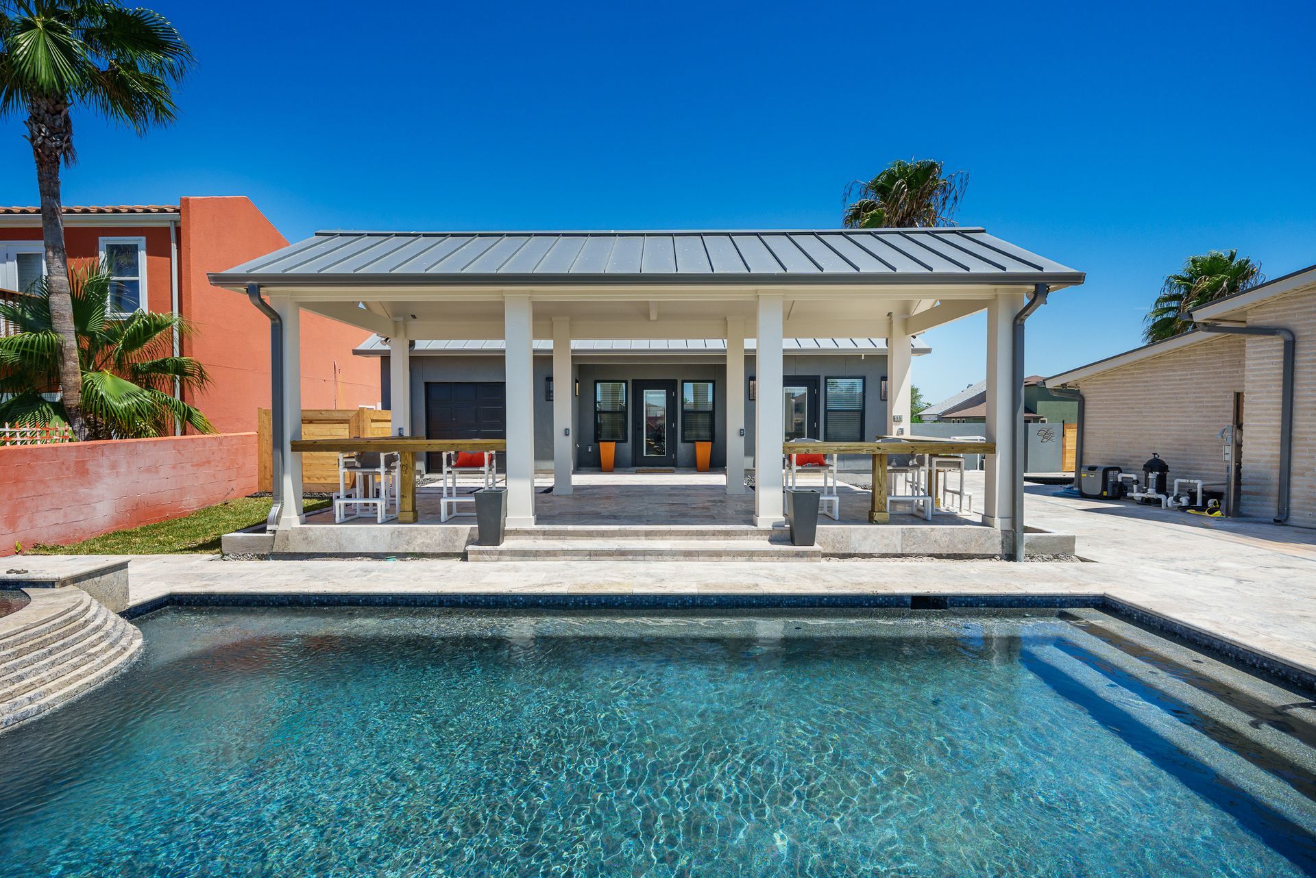 A house with a swimming pool in front of it