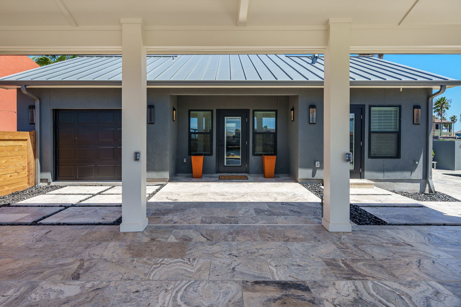The front of a house with columns and a driveway