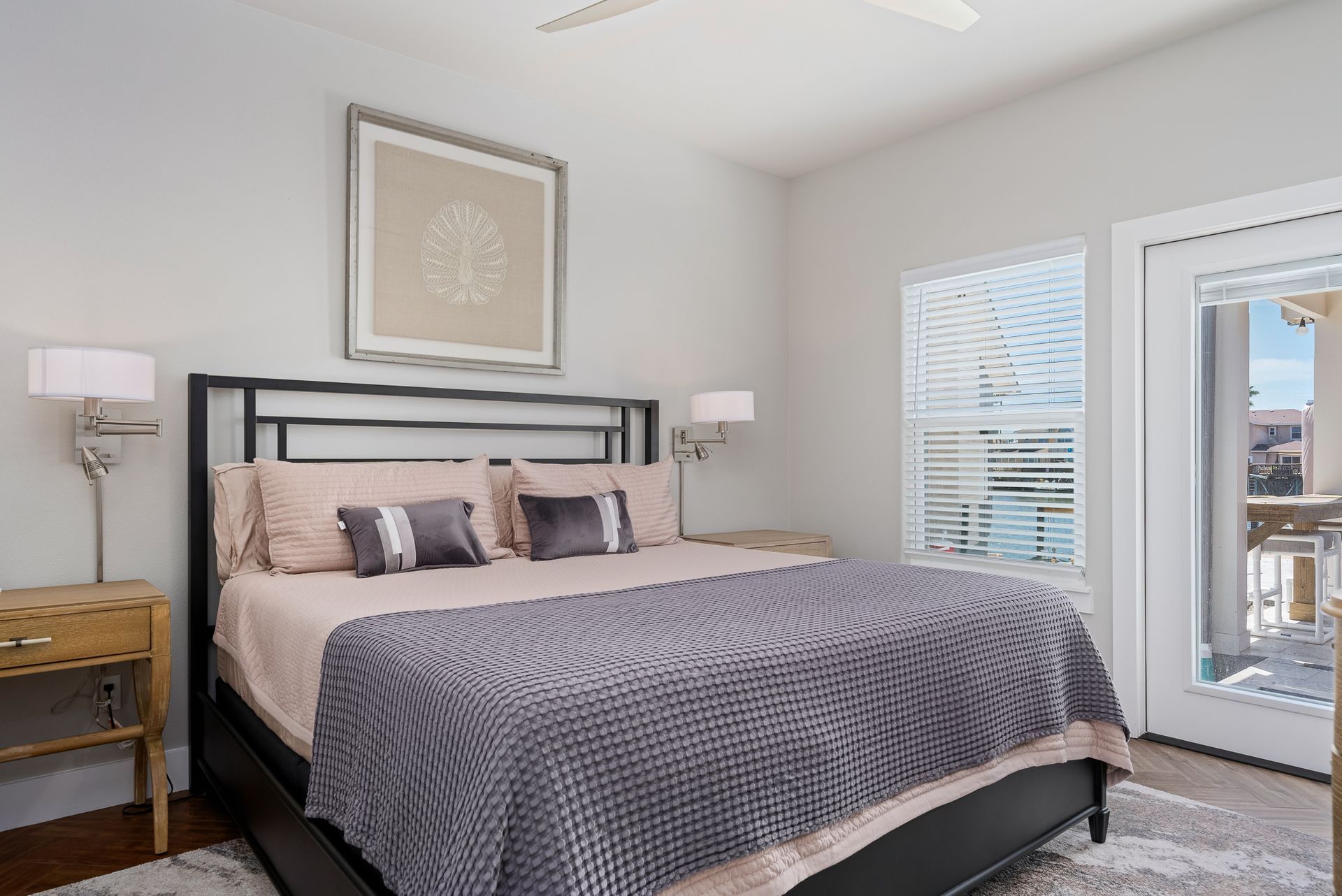 A bedroom with a king size bed and a ceiling fan.