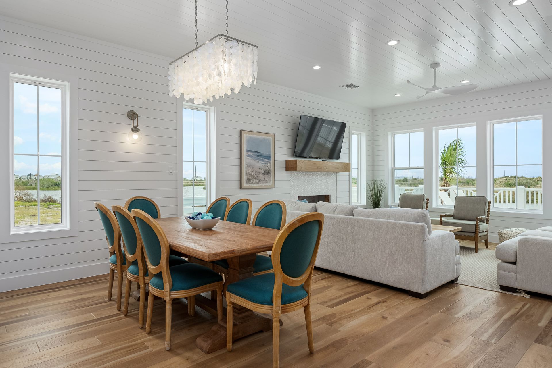 A living room with a dining table and chairs and a couch.
