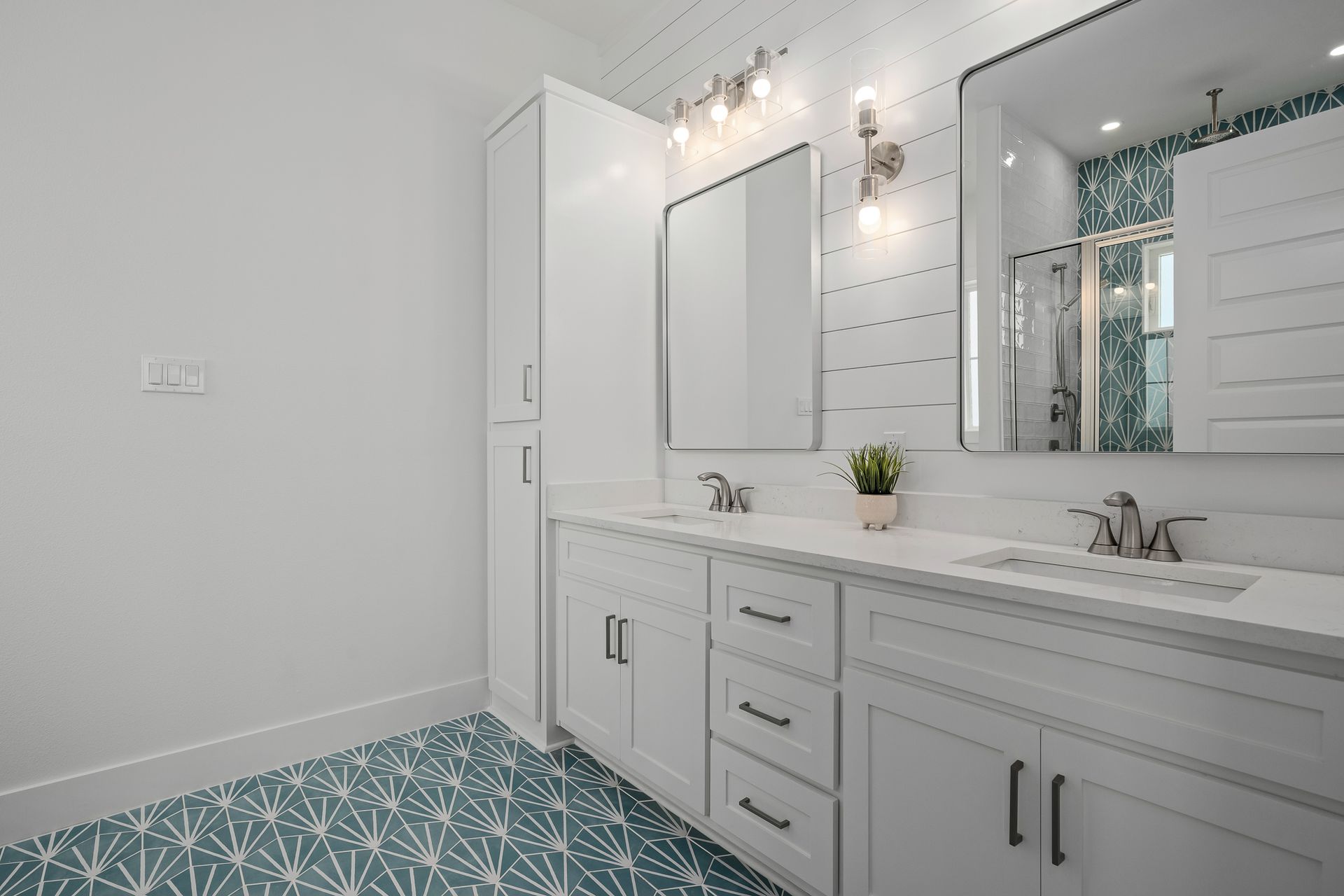 A bathroom with two sinks and a mirror.