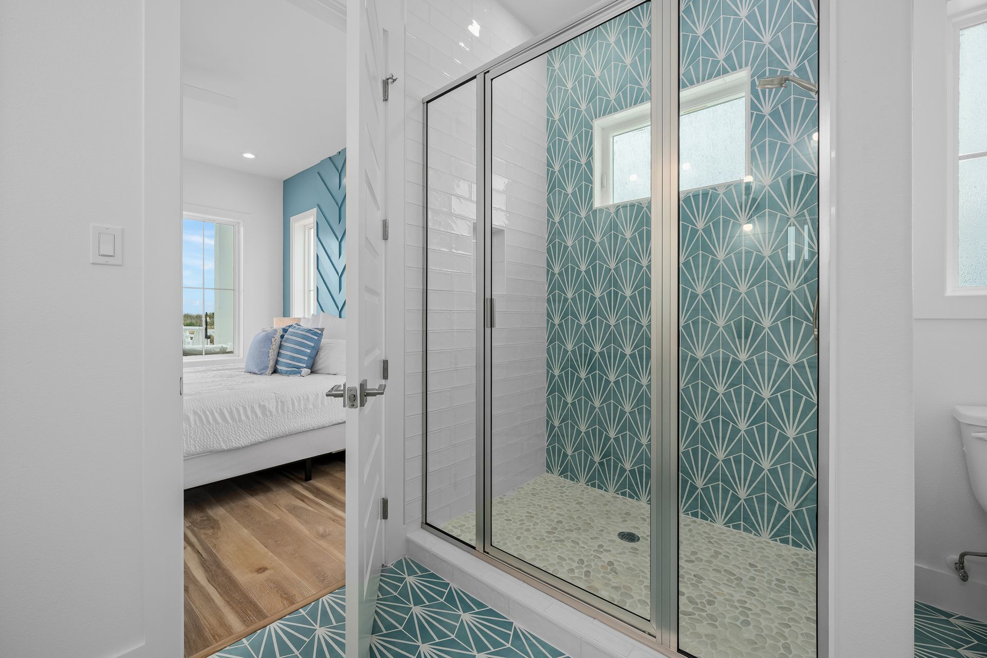 A bathroom with a walk in shower and a toilet.