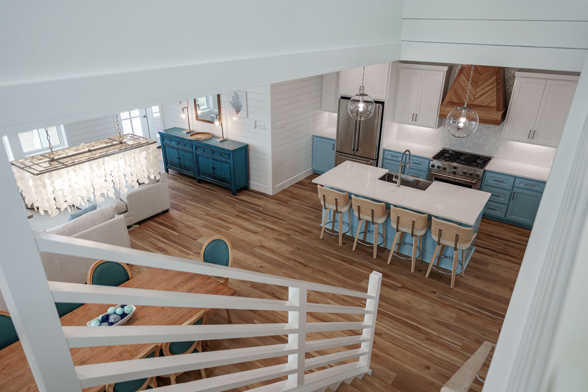 An aerial view of a kitchen and dining room from the second floor.
