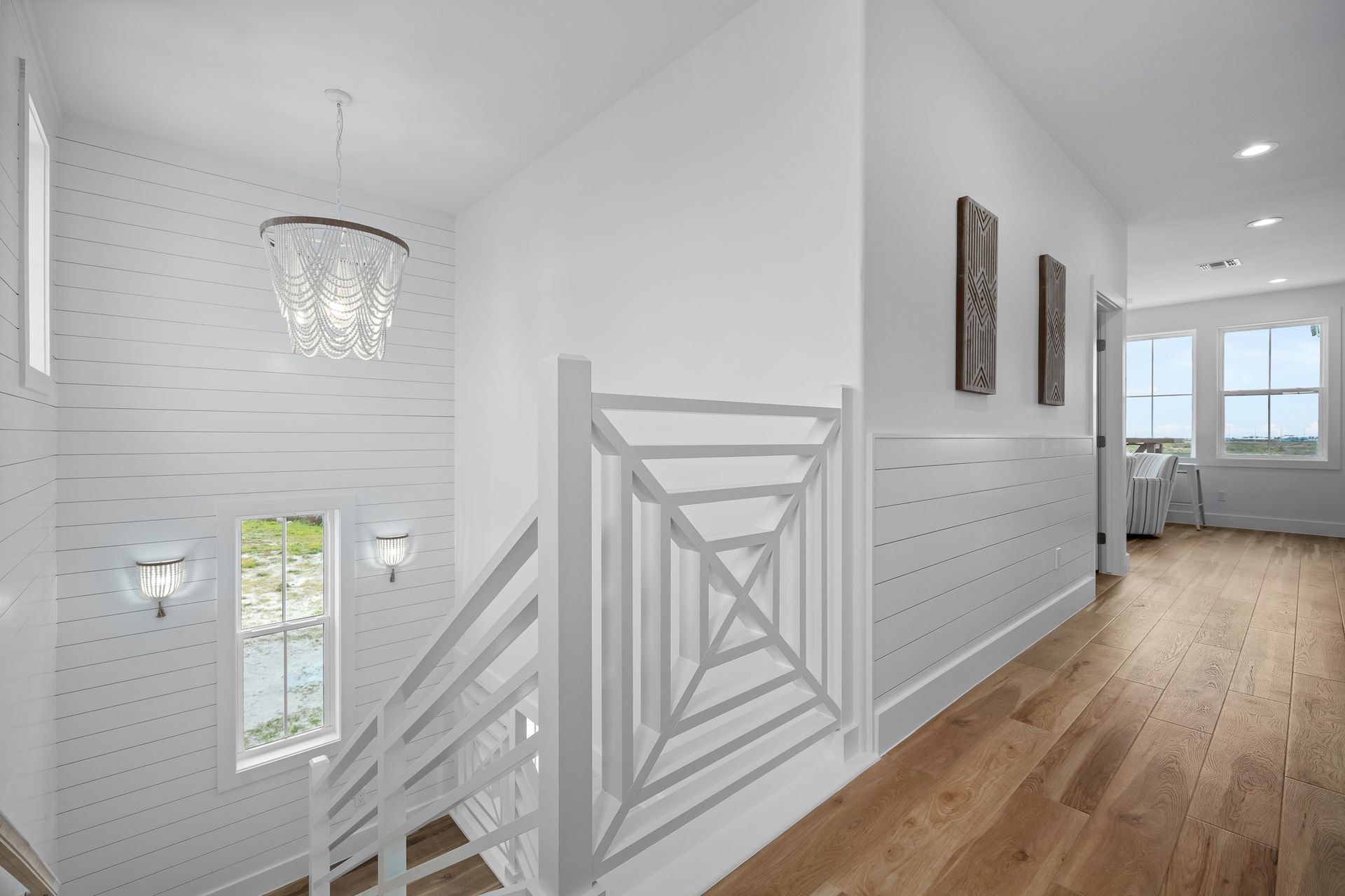 A hallway with stairs leading up to the second floor of a house.