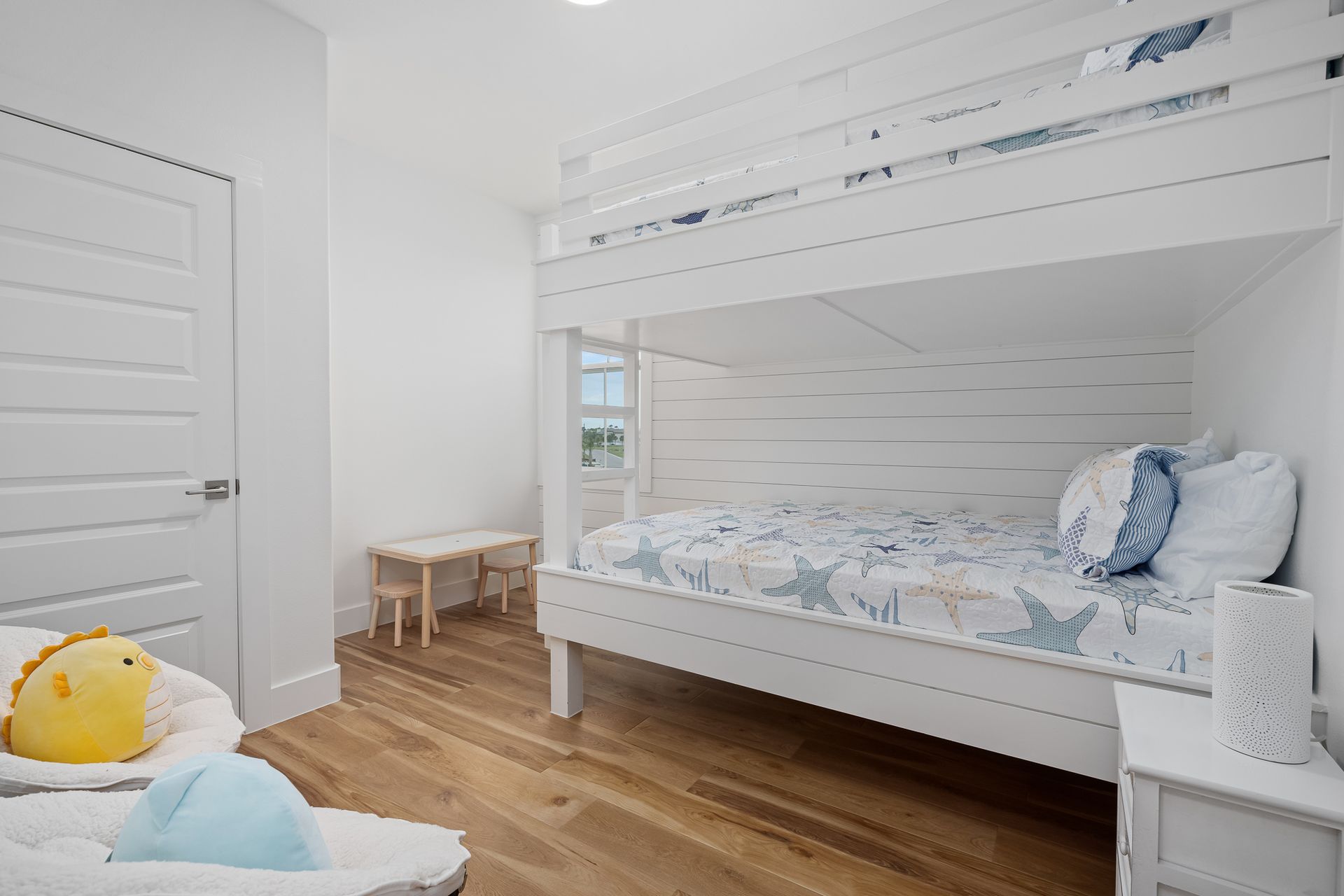 There is a bunk bed in the middle of the room.