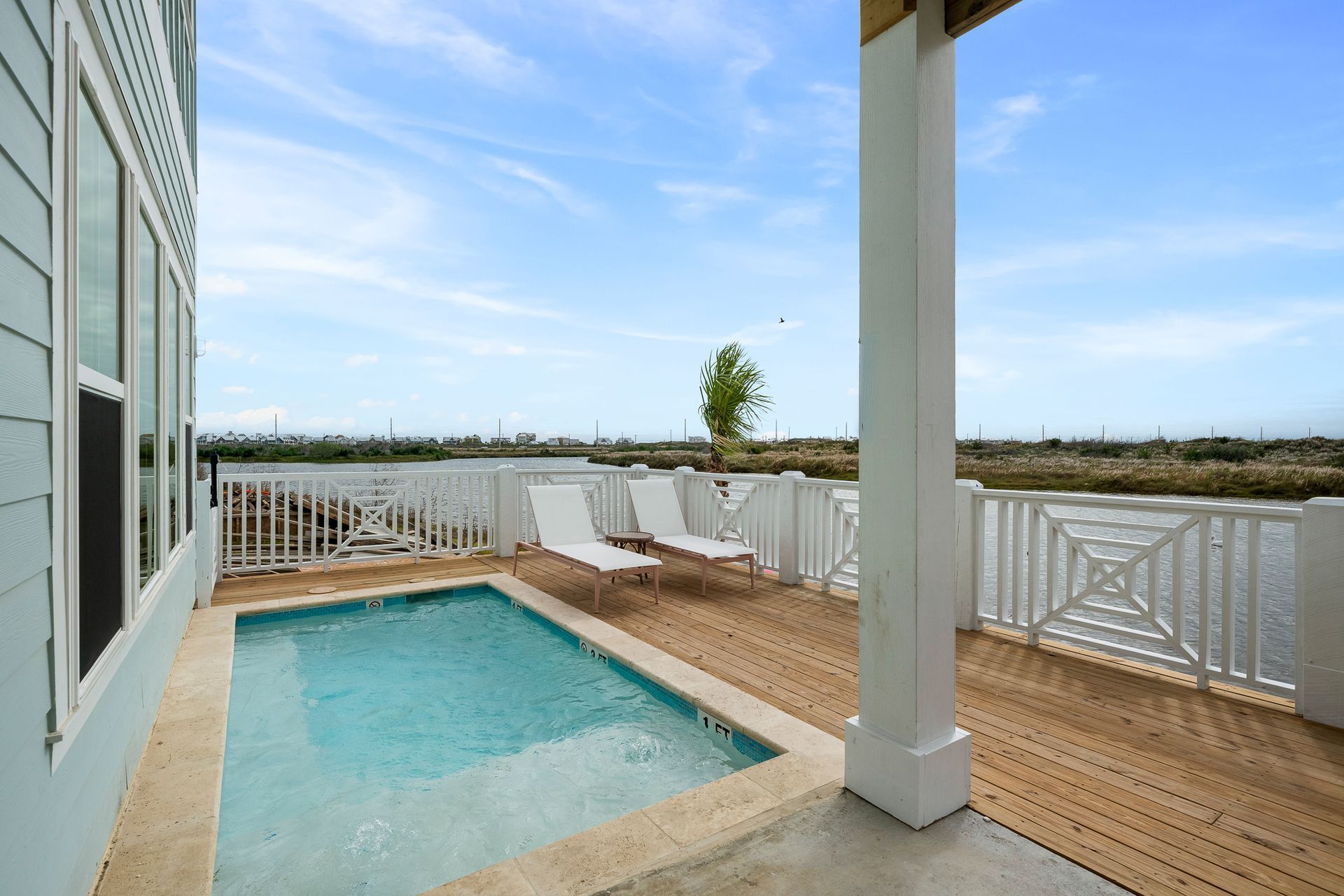 A small swimming pool with a view of a body of water