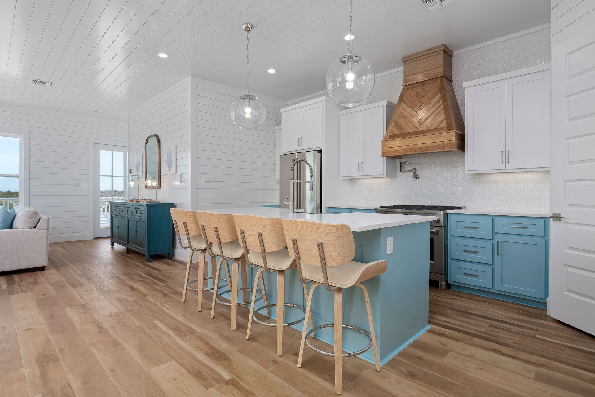 A kitchen with blue cabinets and wooden floors