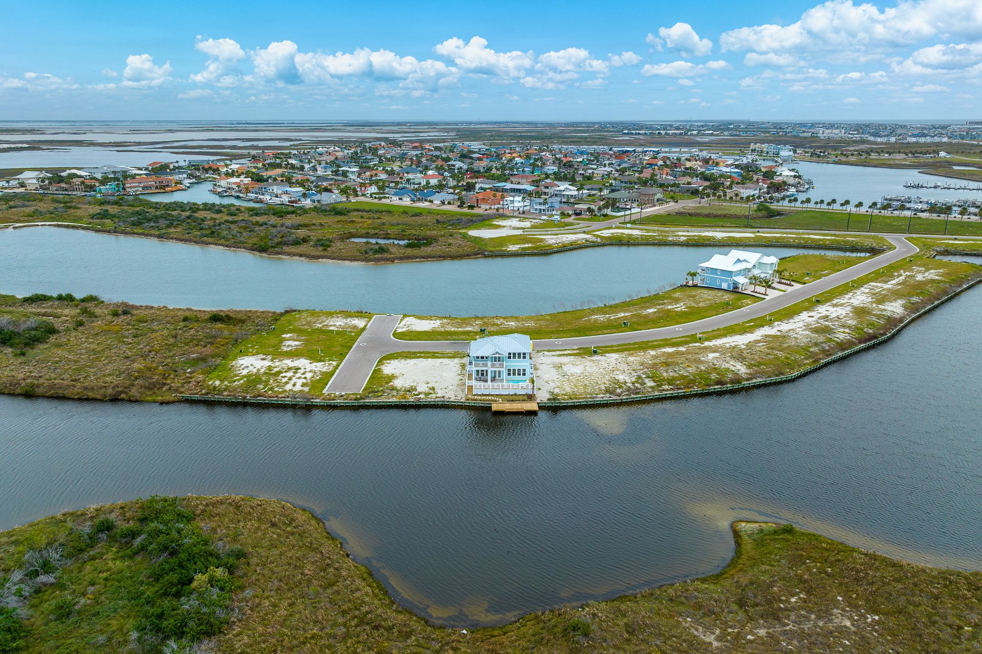 An aerial view of a small island in the middle of a body of water.