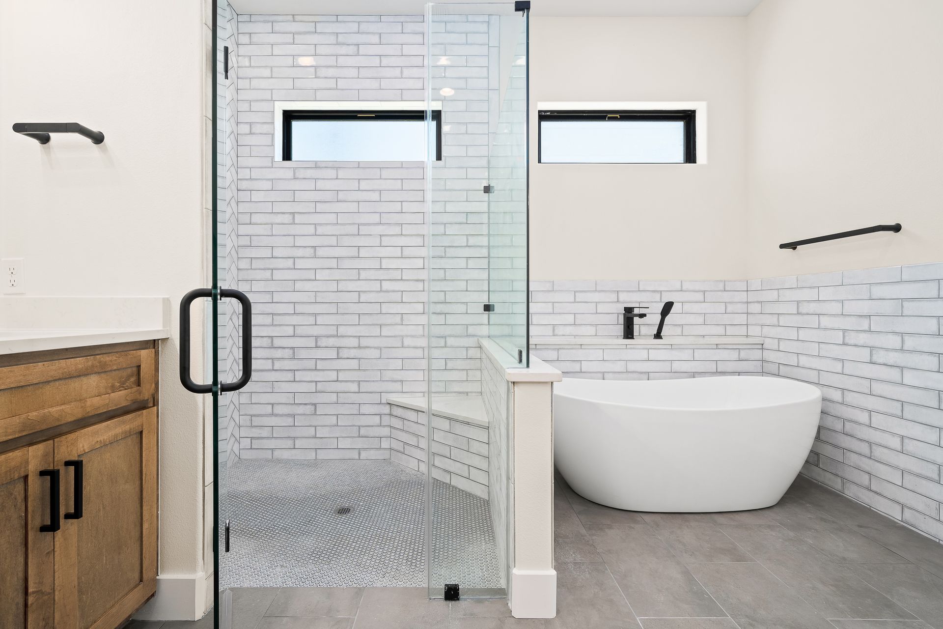 A bathroom with a bathtub and a walk in shower.