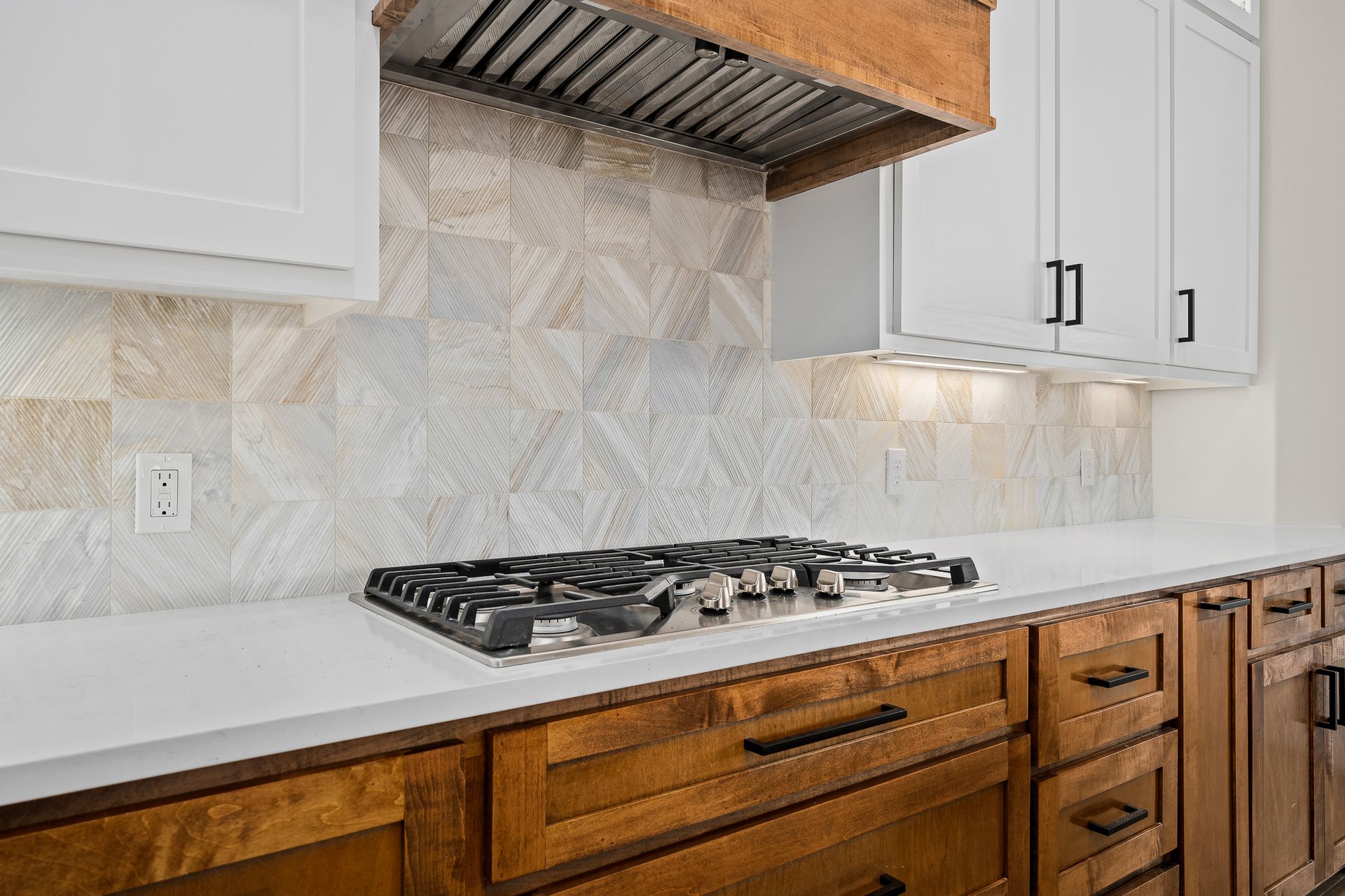 A kitchen with wooden cabinets and a stove top oven.