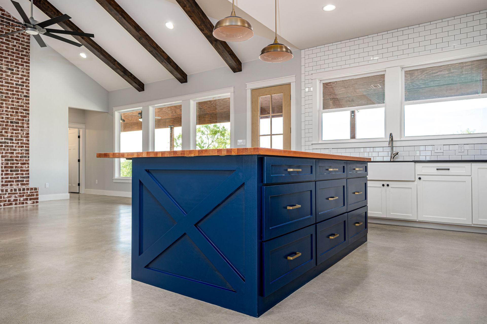 There is a large blue island in the middle of the kitchen.