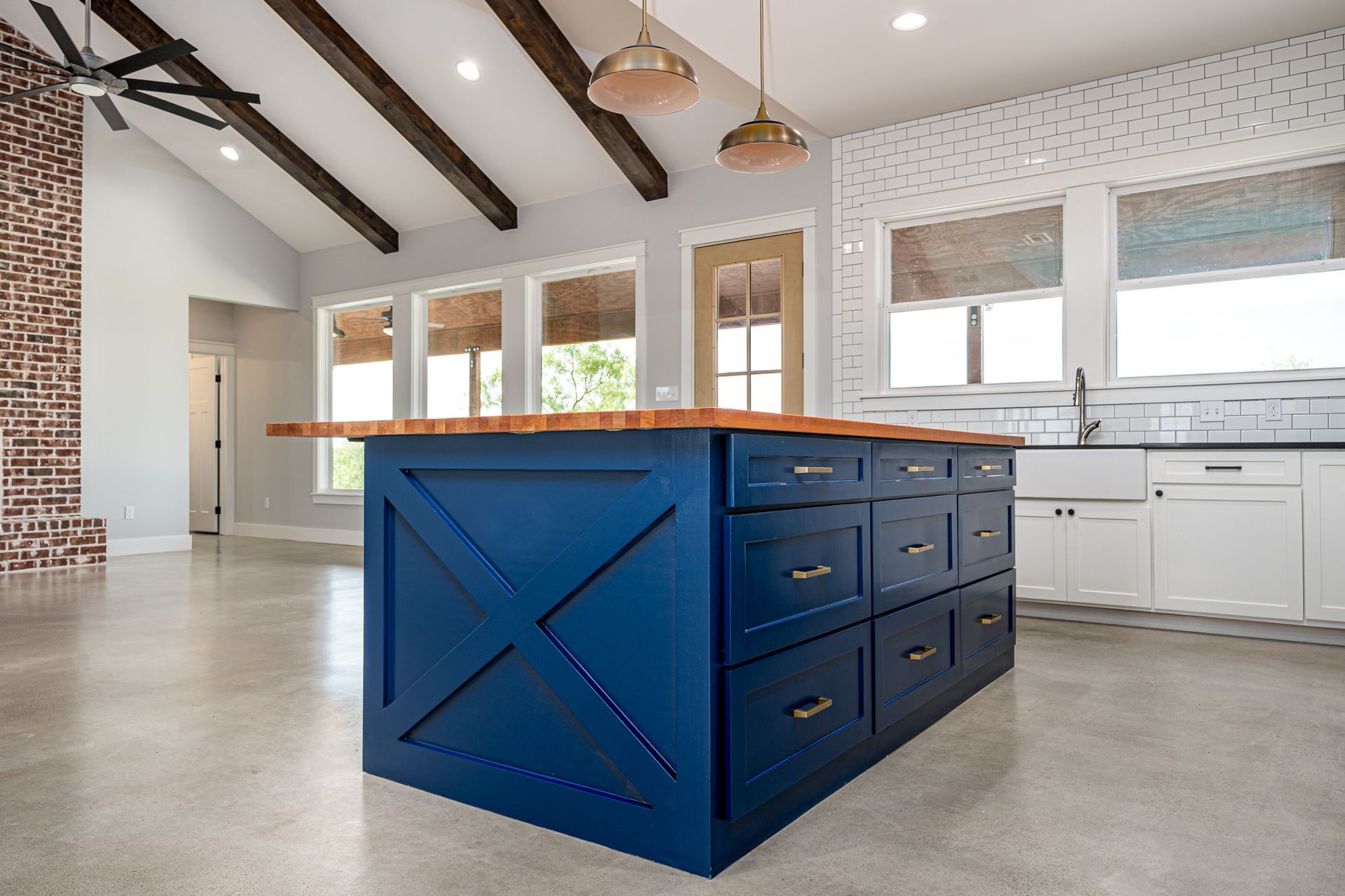 There is a large blue island in the middle of the kitchen.