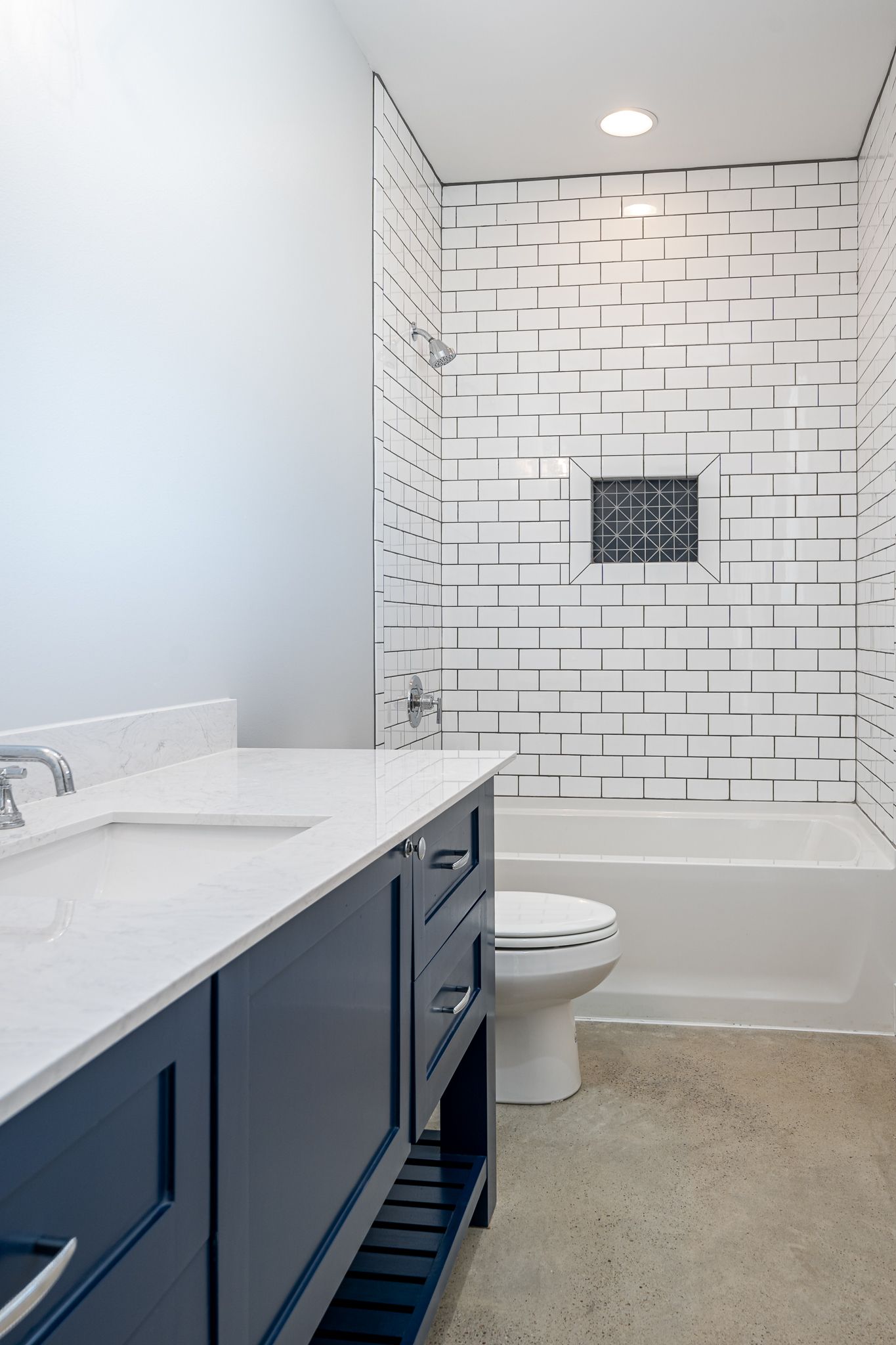 A bathroom with a sink , toilet , bathtub and shower.