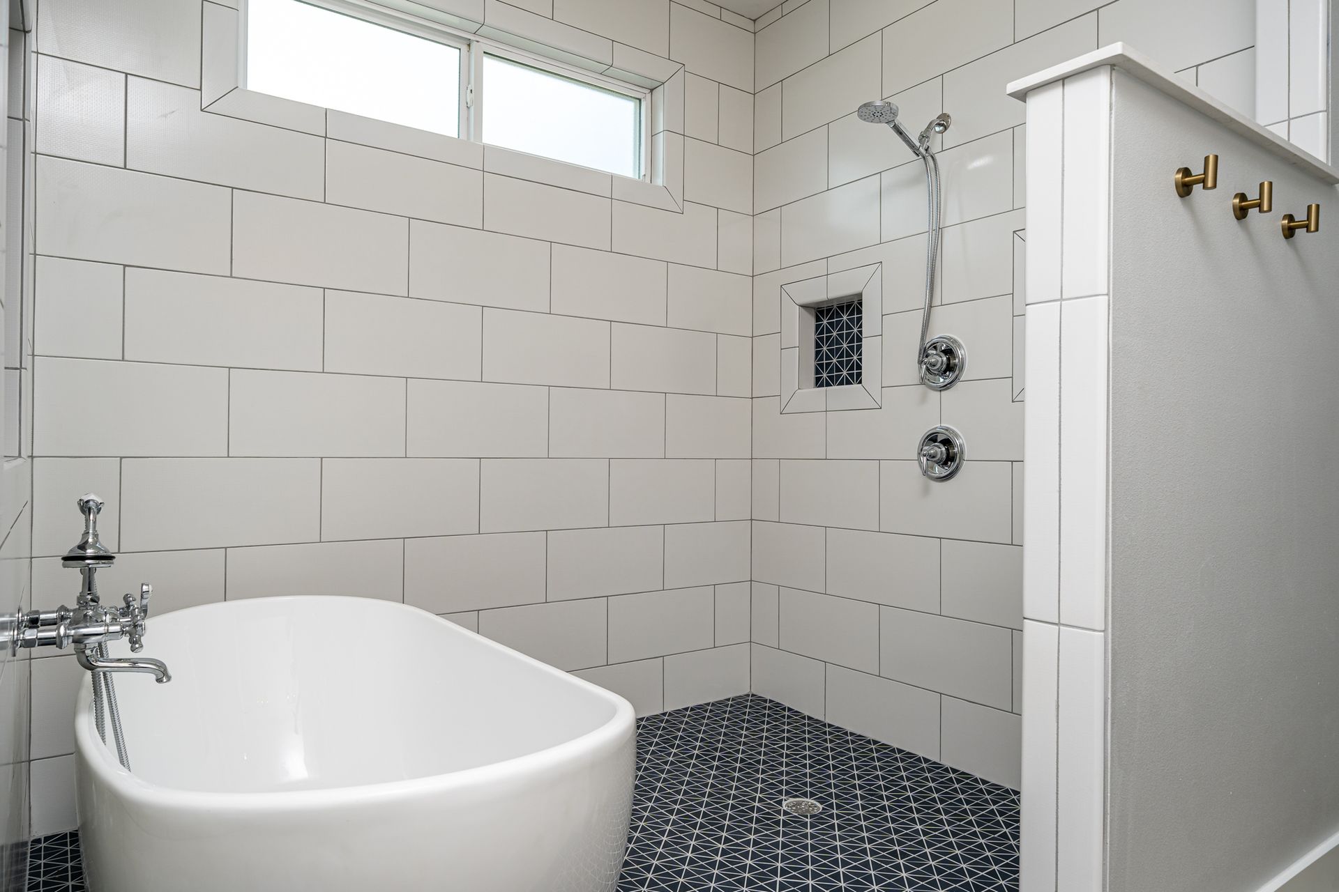 A bathroom with a bathtub and a walk in shower