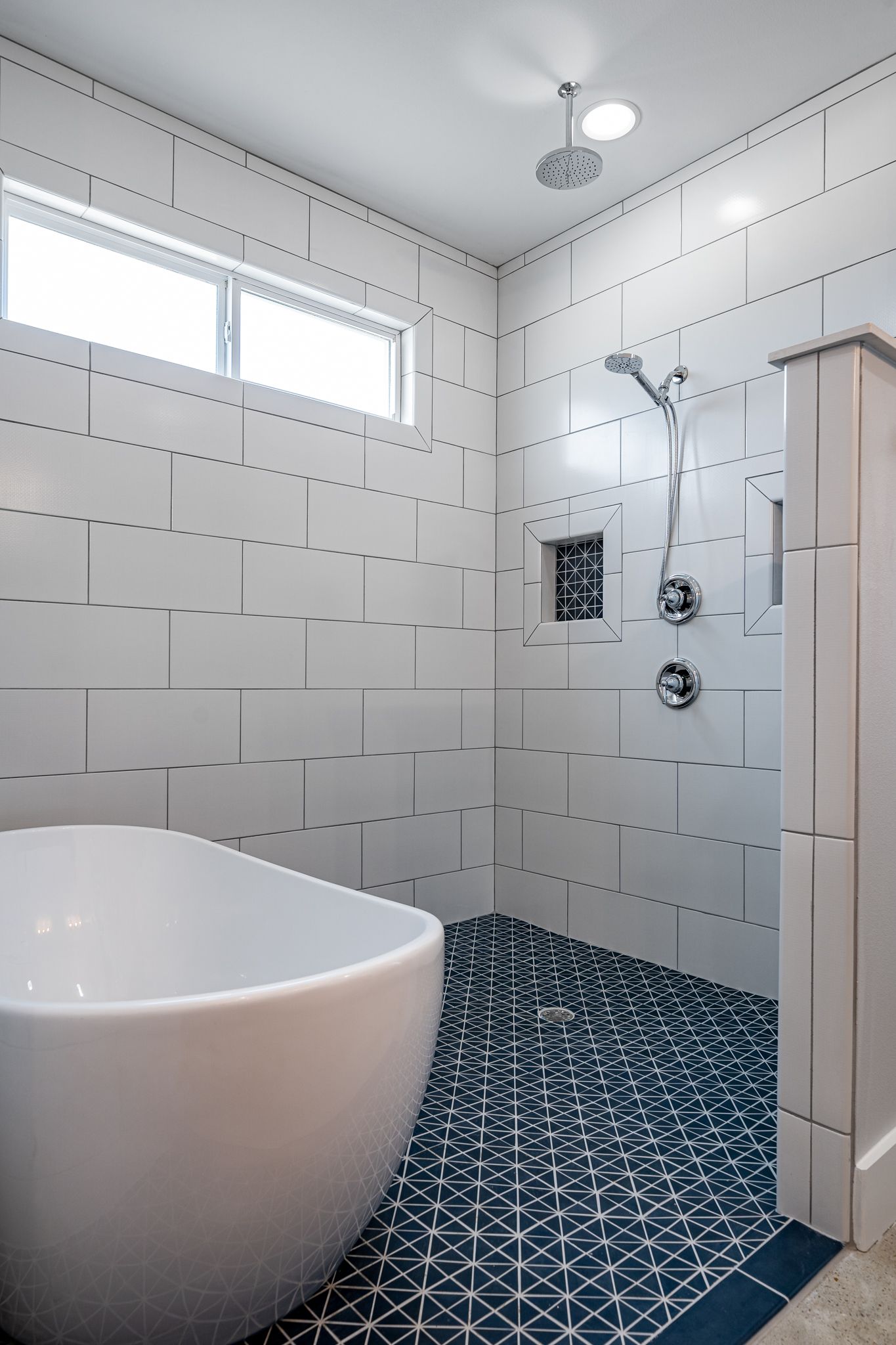 A bathroom with a bathtub and a walk in shower.