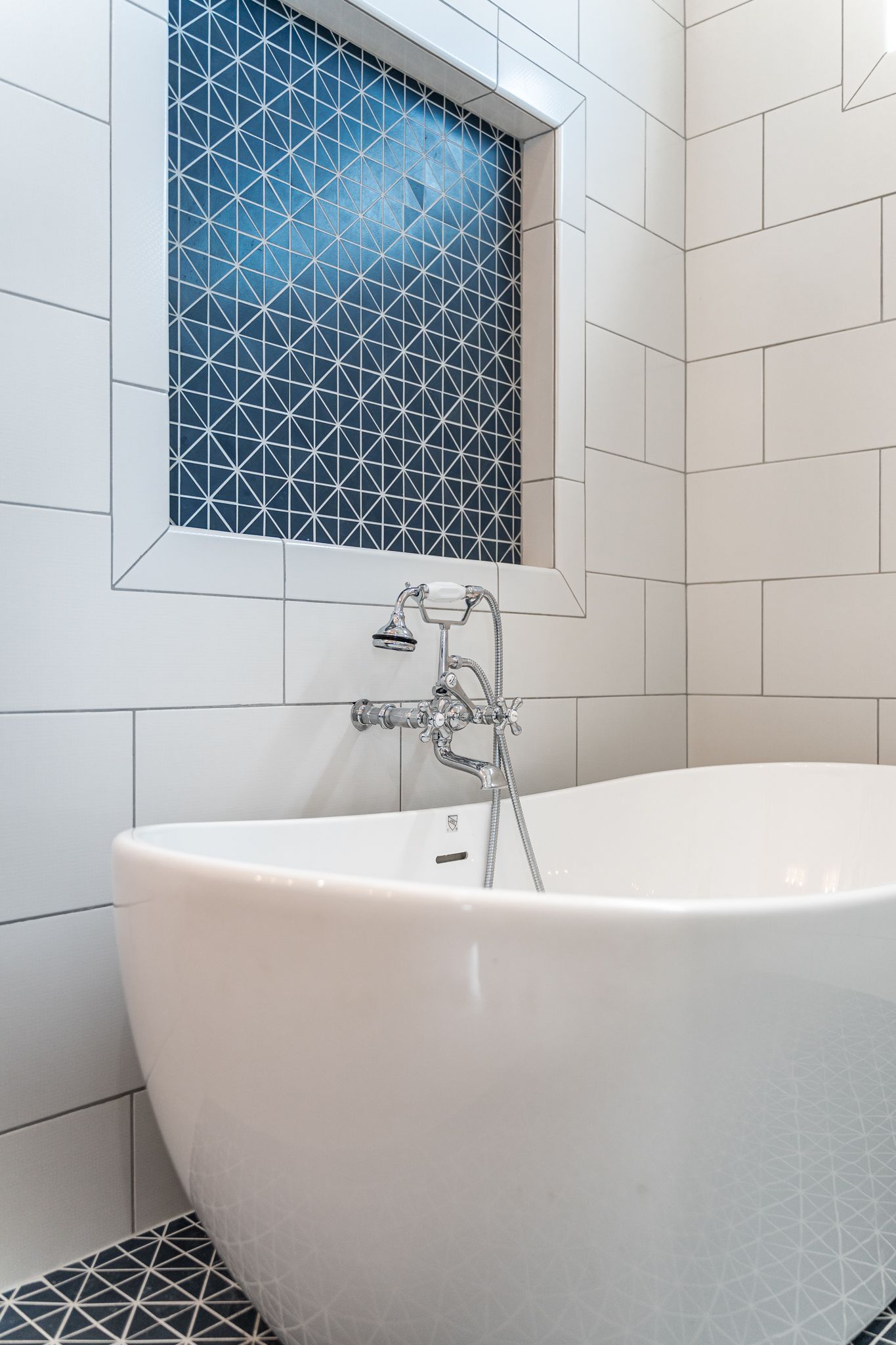 A bathroom with a bathtub and a window.