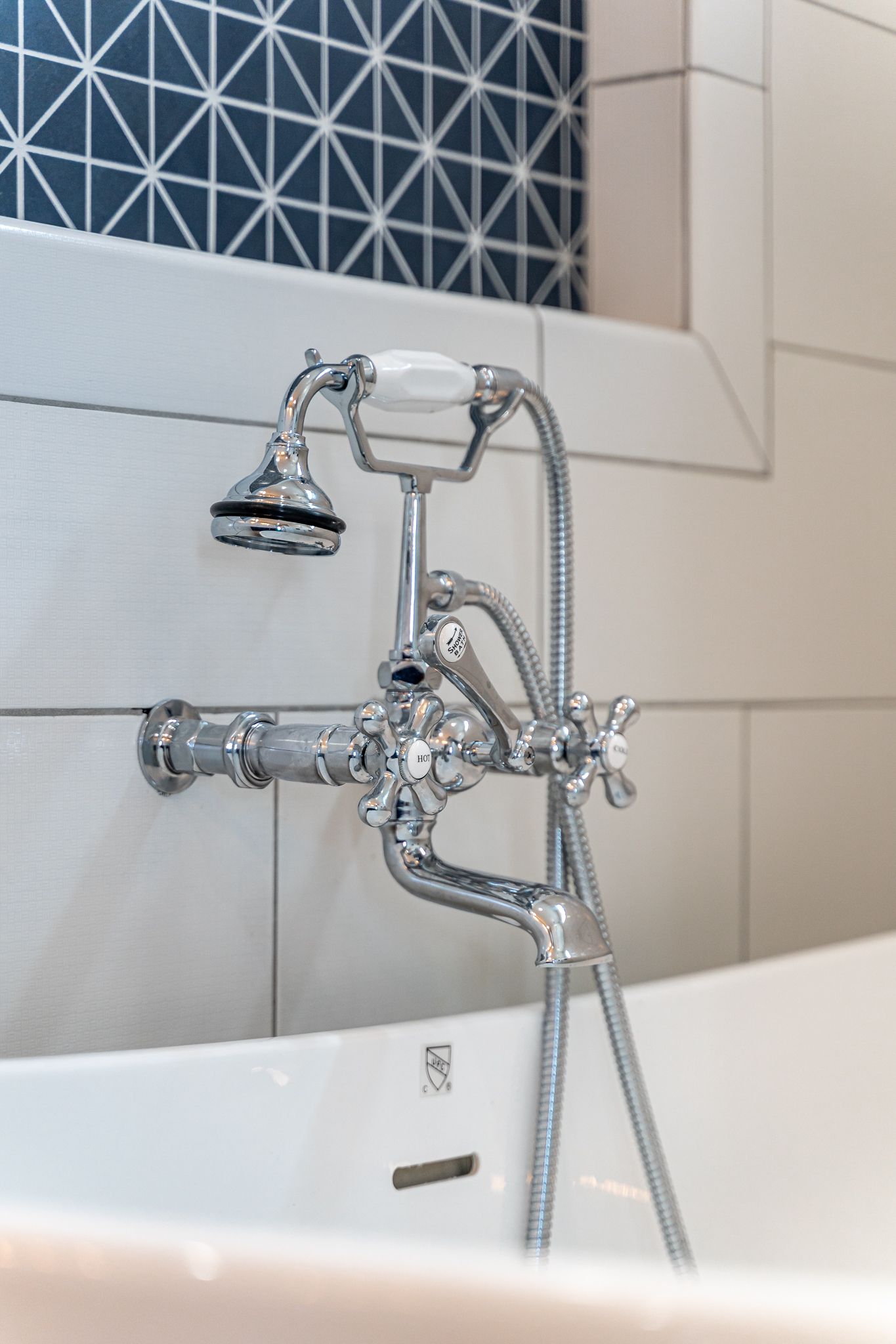 A bathtub with a shower head attached to it.